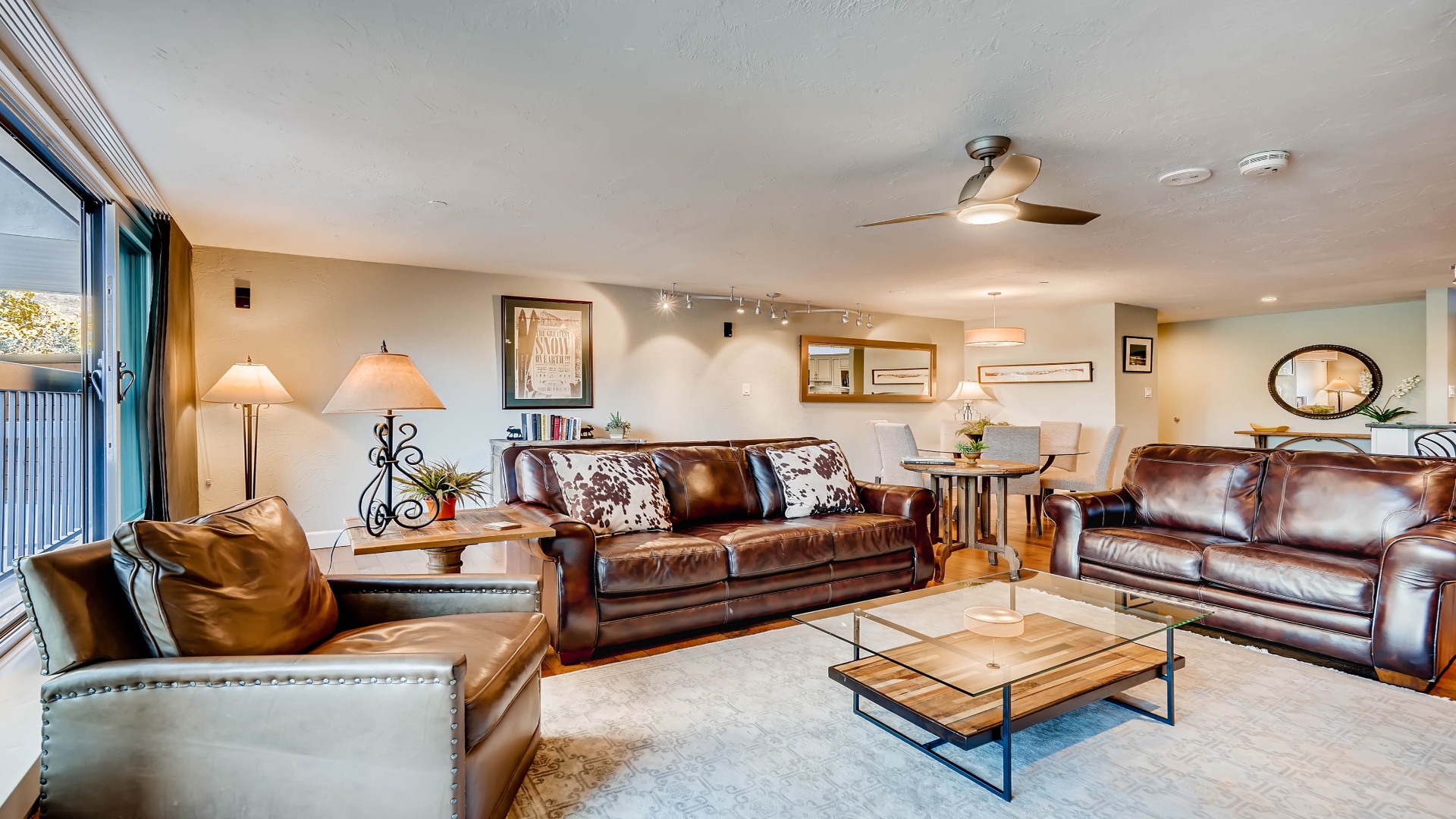 Sink into rich leather sofas with rustic-chic style and enjoy cozy conversations in this open, sunlit living space—your perfect home base for mountain getaways.
