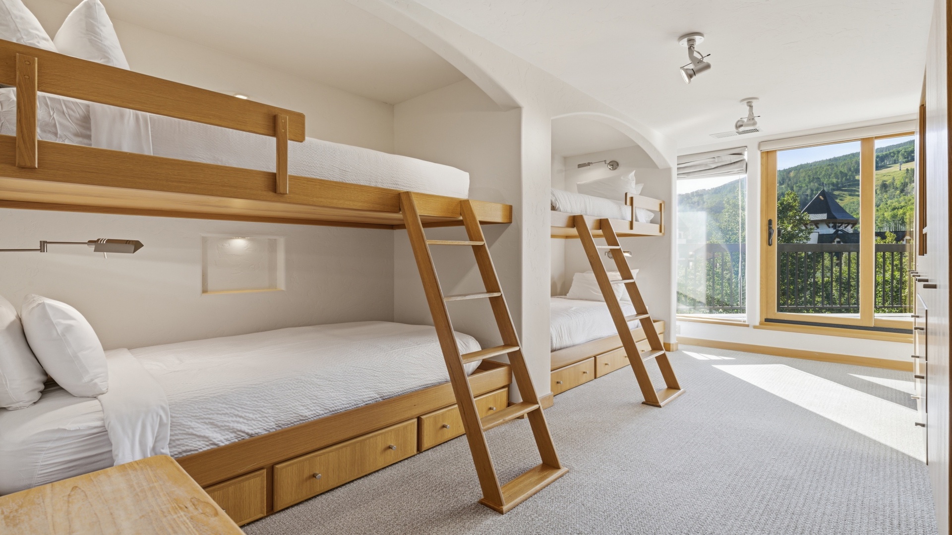 Cozy bunk room with crisp linens and mountain views—perfect for kids or friends to settle in together after a day of adventure.