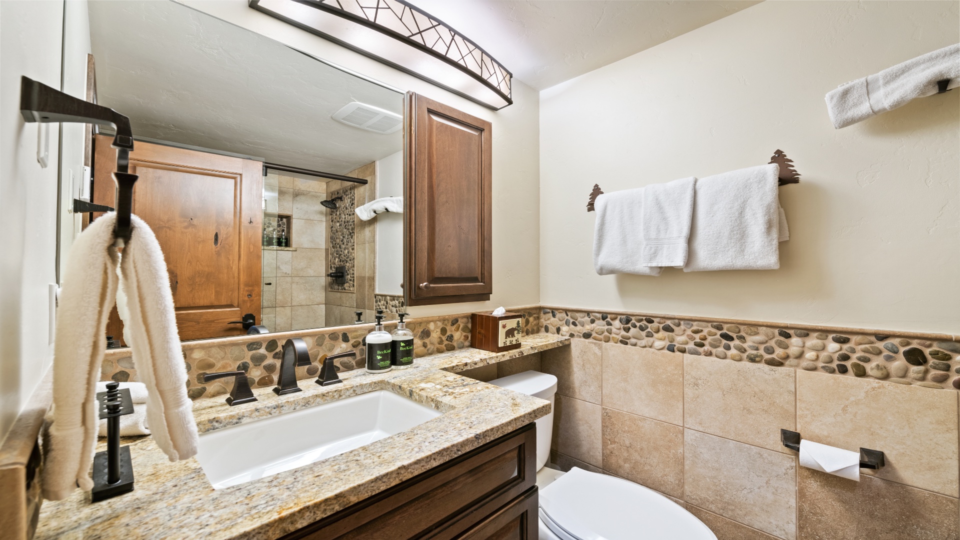 Fresh towels, a granite vanity, and elegant pebble accents make your bathroom a soothing retreat after a day of adventure.