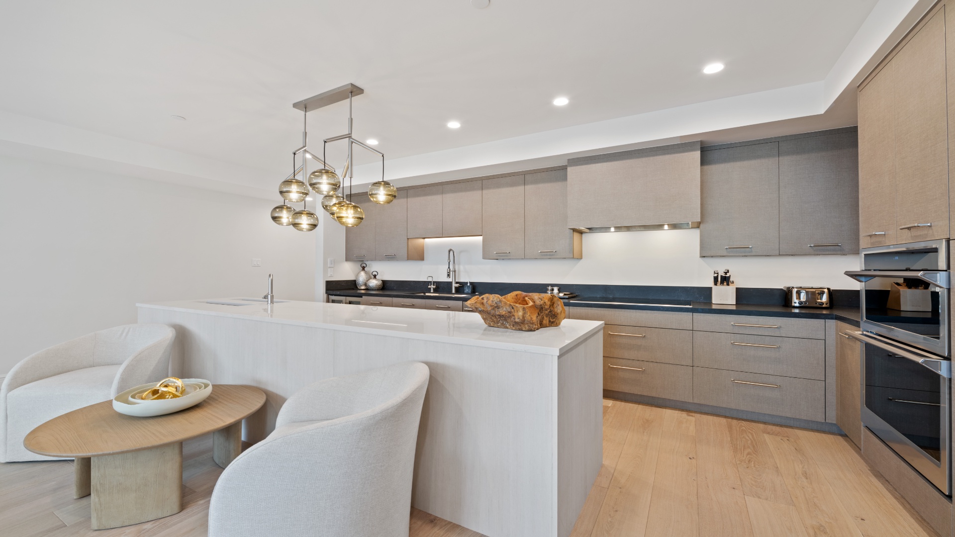 Cook your favorite meals in this sleek, fully-equipped kitchen with quartz countertops, stainless appliances, and a stylish breakfast nook where you can sip your morning coffee.