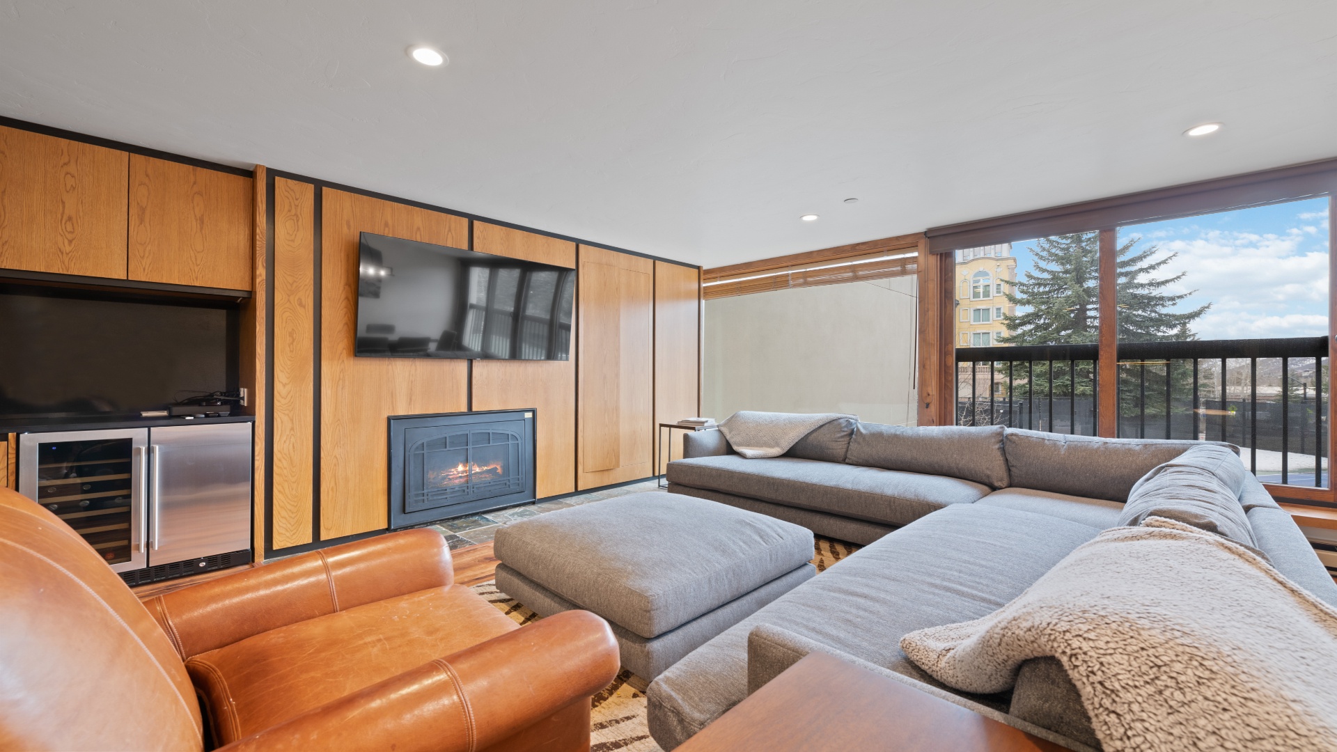 Sink into plush sectional seating by your cozy fireplace while enjoying mountain views through oversized windows—your perfect retreat after a day of adventure.