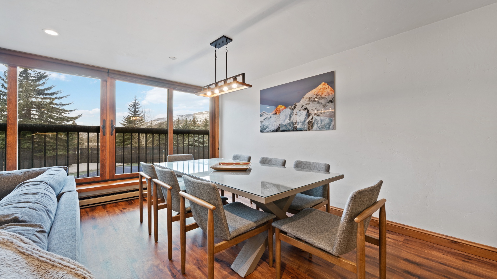 Gather around your modern dining table and savor meals with stunning mountain views framing every moment. Natural light fills this inviting space, designed for memorable conversations.