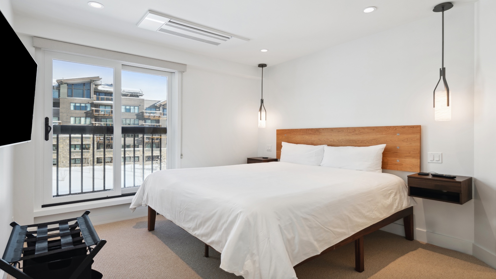 Wake up to mountain views in your serene bedroom with plush bedding, modern lighting, and a private balcony to enjoy your morning coffee.