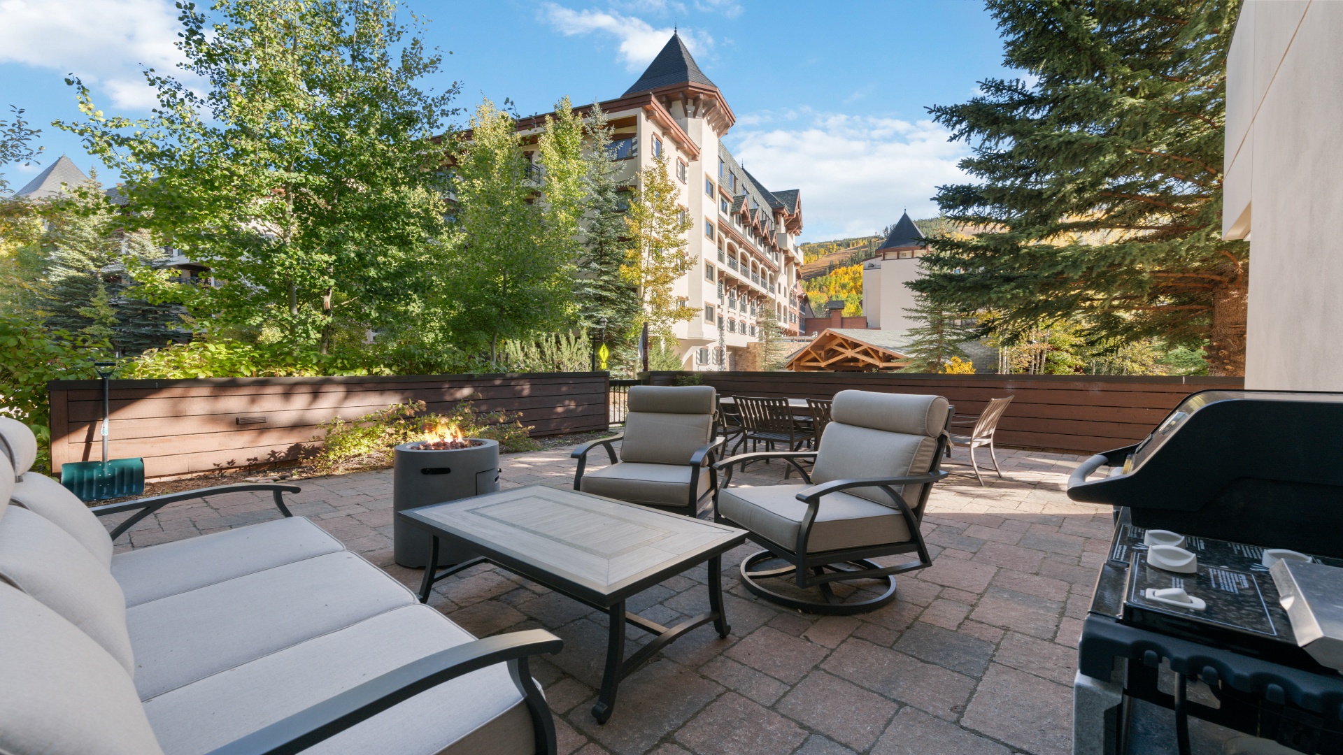 Your private patio invites you to unwind in cushioned seating, surrounded by trees and alpine architecture. Fire up the grill, gather around the fire pit, and let mountain air refresh you.