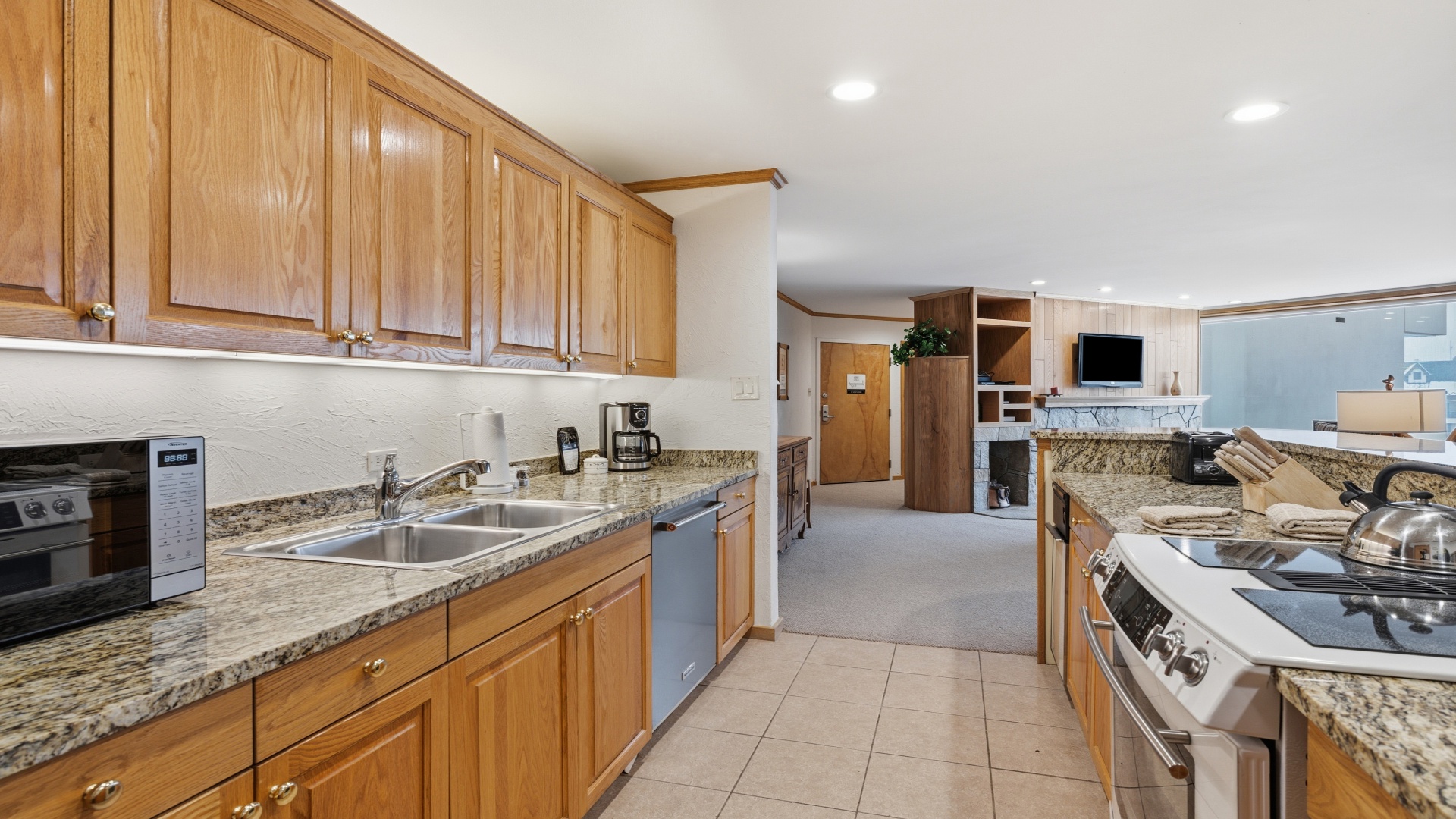 Prepare your favorite meals in this spacious, fully-equipped kitchen featuring granite countertops, quality appliances, and plenty of storage to make you feel right at home.
