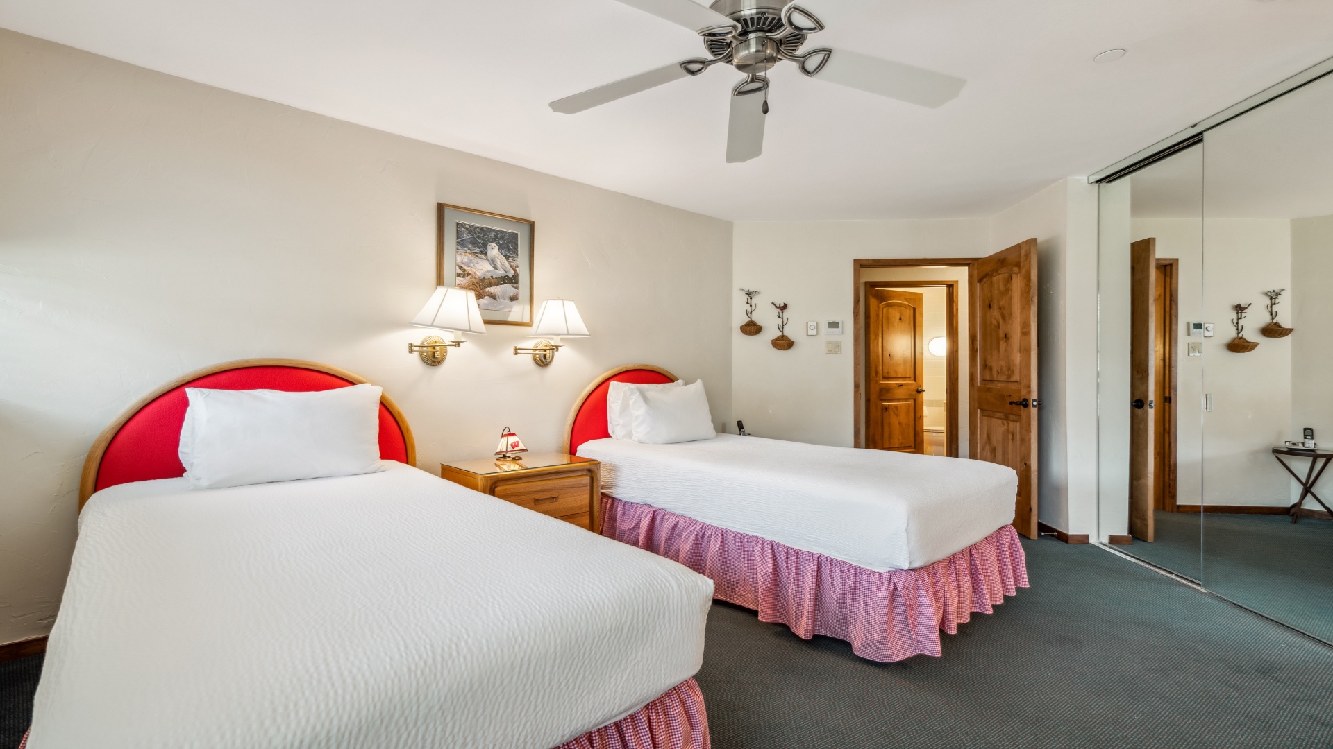 Your spacious room features two plush beds with crisp linens, warm ambient lighting, and a ceiling fan to keep you comfortable throughout your stay.