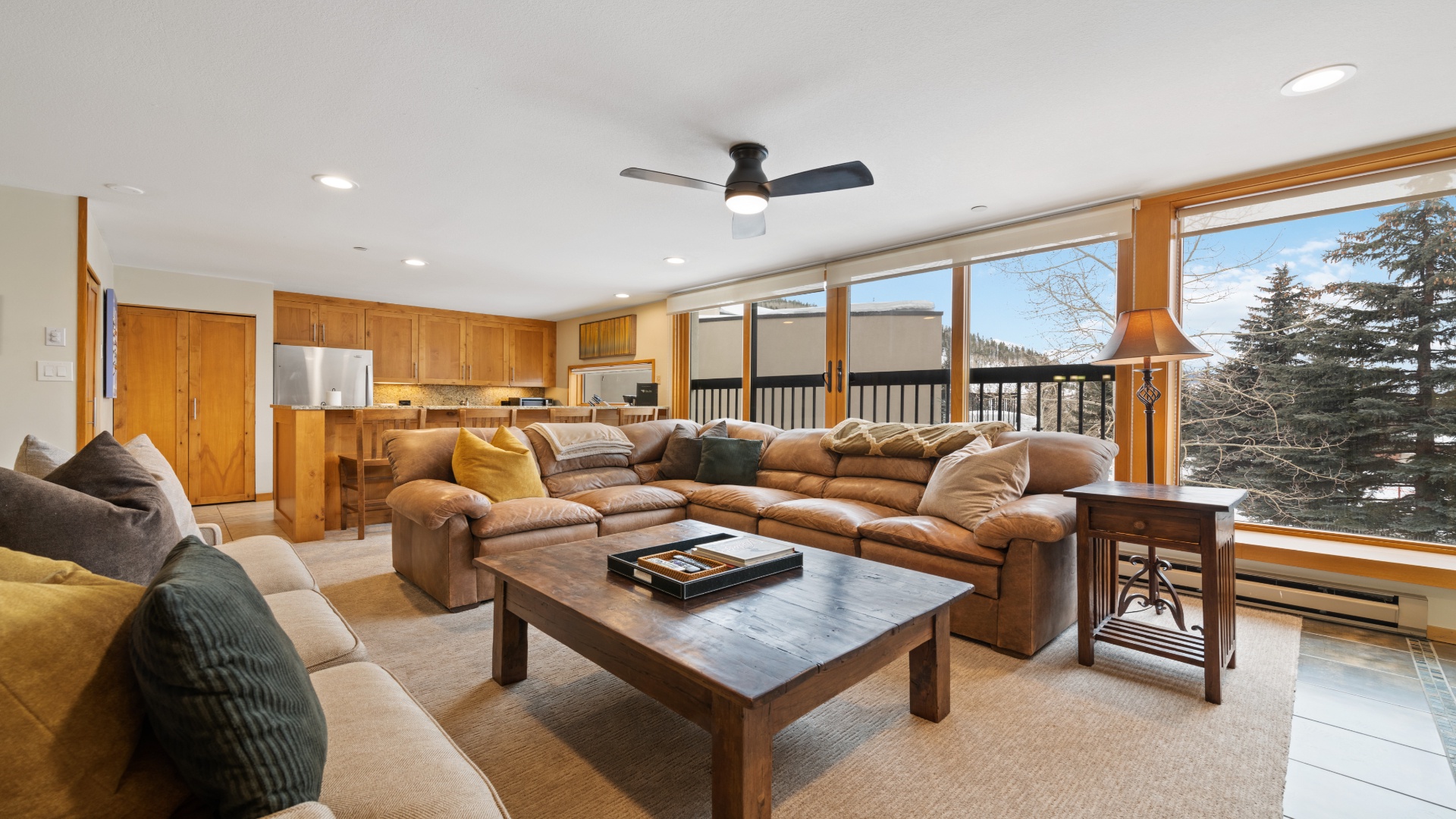 Sink into plush leather sofas in this bright, open living space where mountain views through panoramic windows invite you to unwind after your adventures.