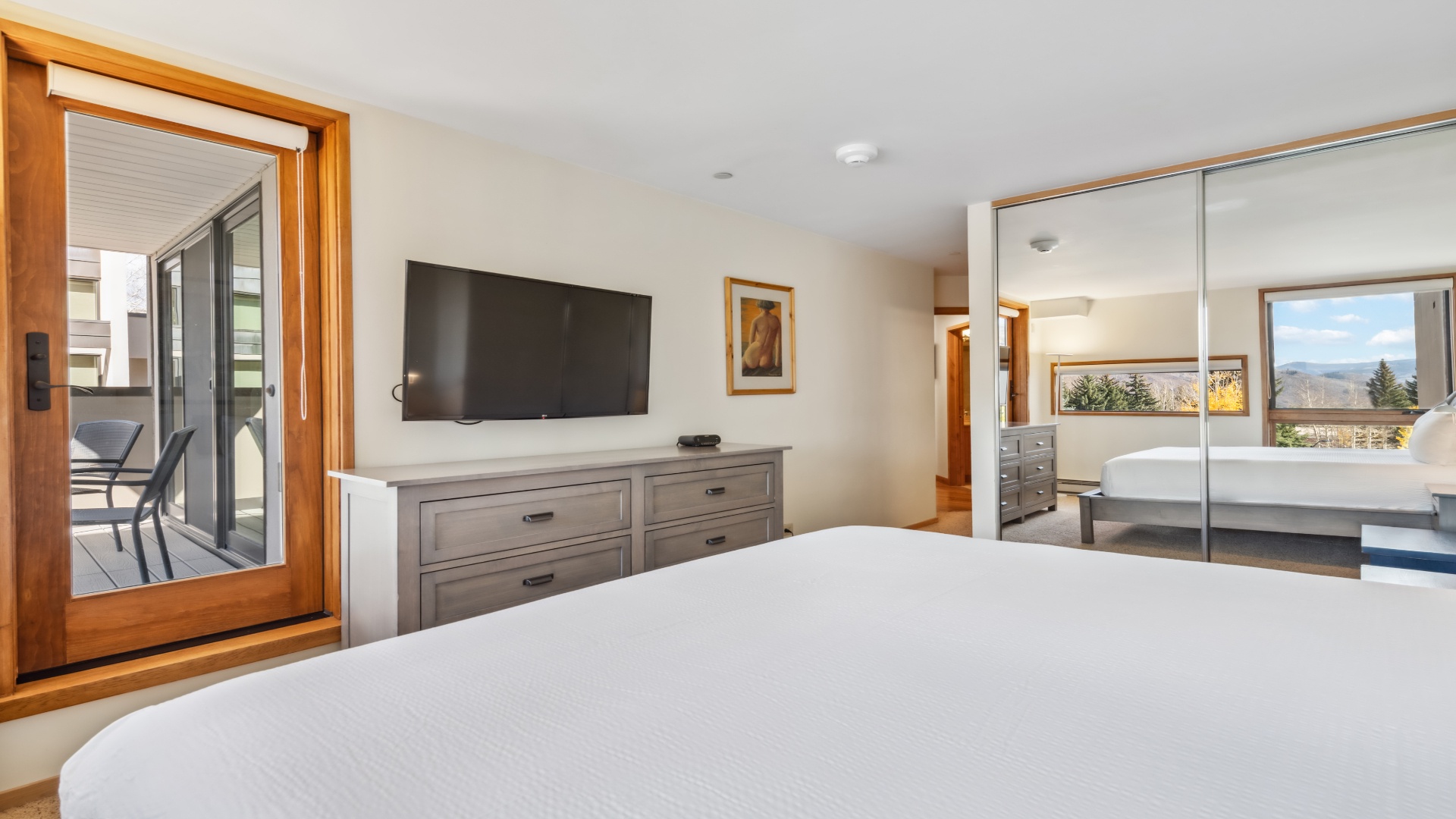 Sink into crisp linens and wake to mountain views framed by your private balcony. Stylish furnishings and warm wood accents create your perfect retreat.