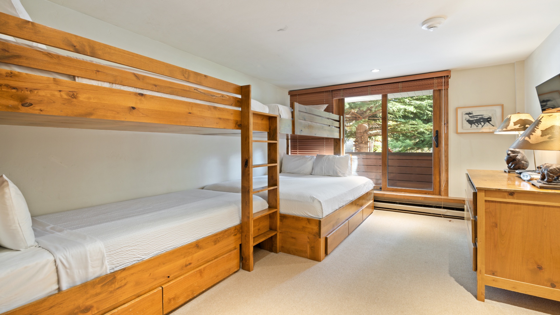 Your kids will love bunking together in this cozy retreat, complete with warm wood furnishings, plush bedding, and a private balcony for mountain air.