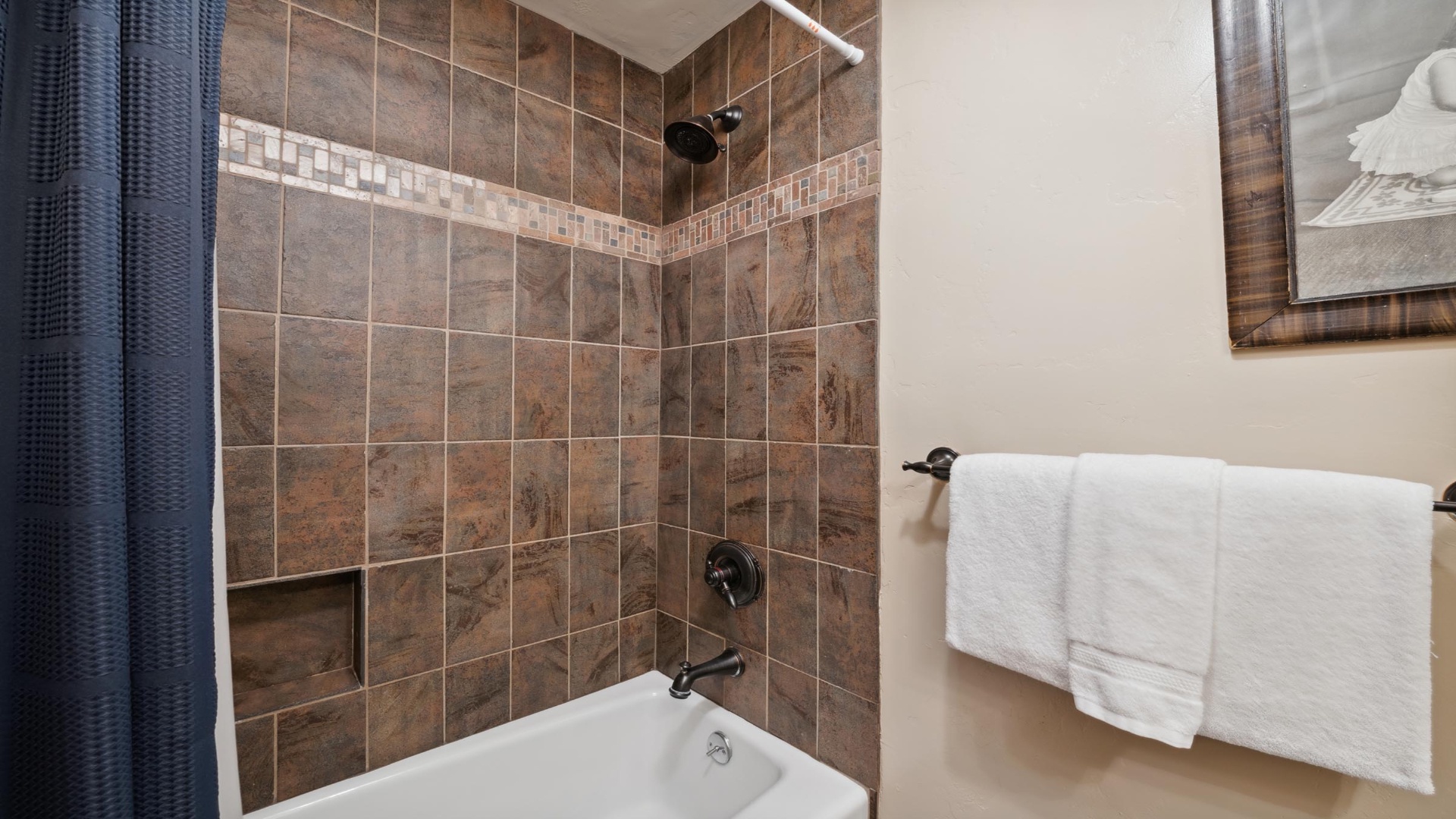Step into your own spa-like retreat, where warm-toned tile and a deep soaking tub await you after a day of adventure. Fresh towels are ready for your arrival.