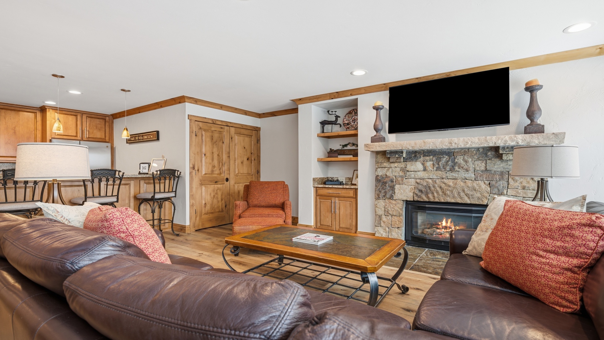 Relax into plush leather seating by your own crackling stone fireplace. The open floor plan invites you to gather around the warmth, watch your favorite shows, and feel completely at home.
