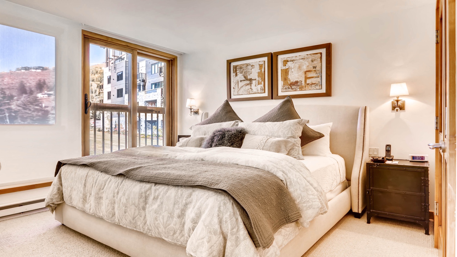 Wake in comfort surrounded by soft linens and mountain views. Your peaceful bedroom features warm wood accents, gentle lighting, and a balcony inviting crisp alpine air in.