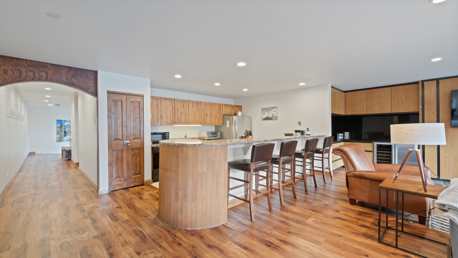 Step into this open, inviting space where your group can gather around the sleek kitchen island—perfect for morning coffee or planning the day's adventures together.