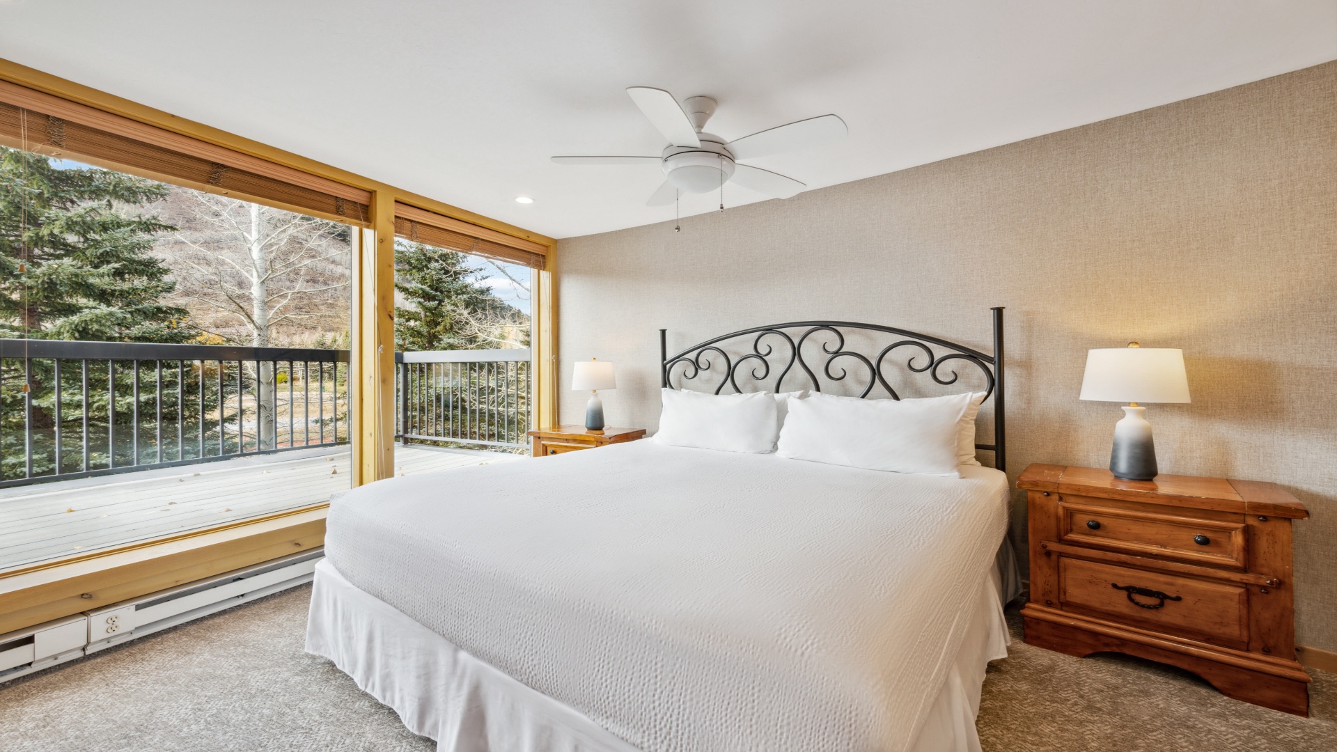 Wake up to crisp mountain air and natural light streaming through your private balcony doors. This peaceful retreat features plush bedding, warm wood accents, and a ceiling fan to keep you comfortable year-round.