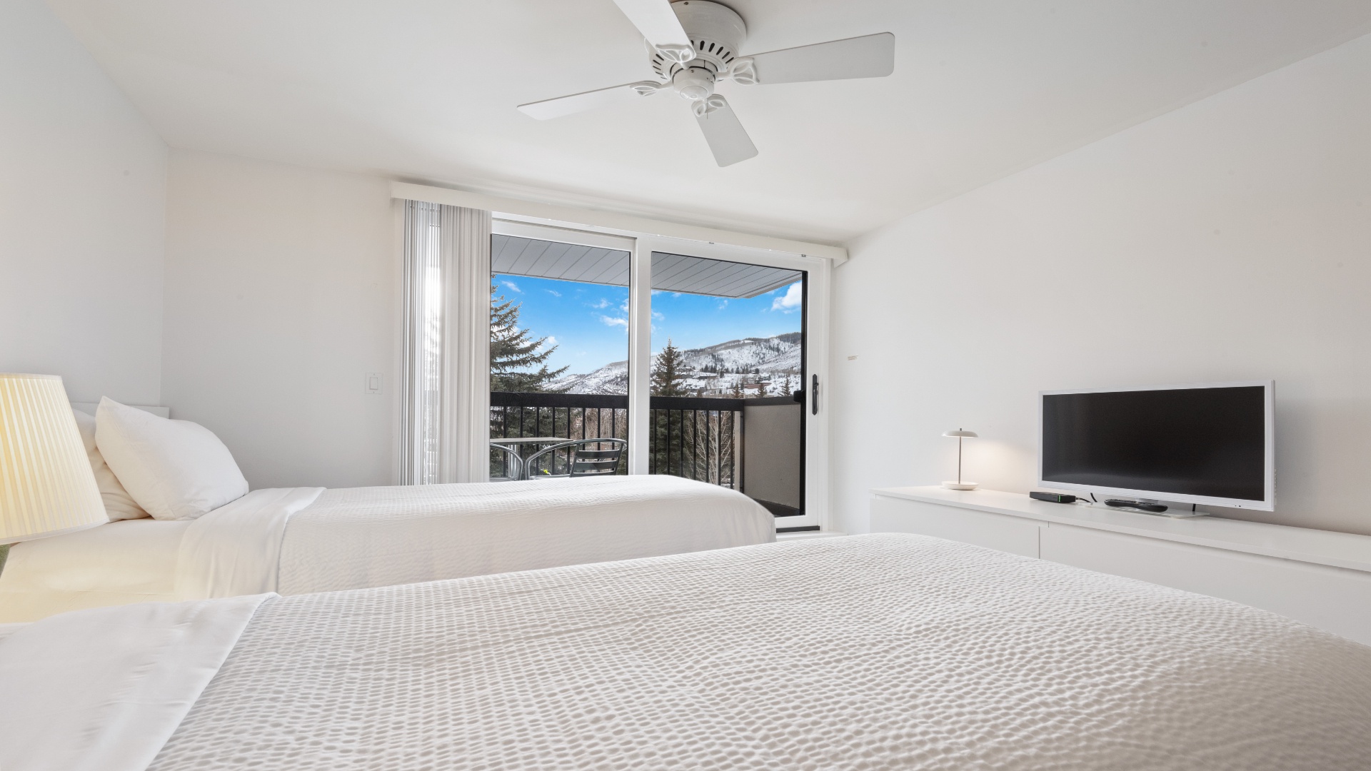 Wake up to breathtaking mountain views from your cozy bedroom, where plush bedding and modern amenities ensure your perfect alpine retreat. Enjoy fresh air from your private balcony.