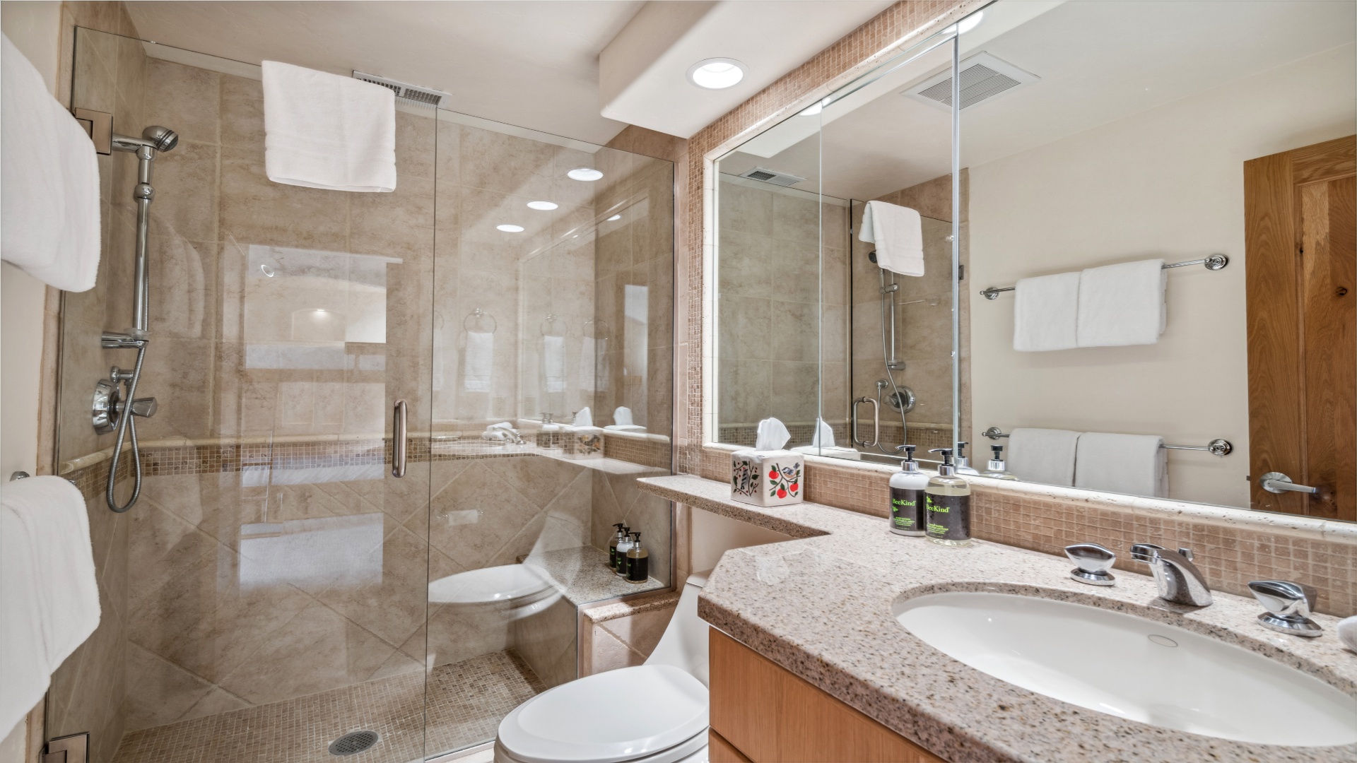 Refresh in your modern bathroom with a spacious walk-in shower, elegant granite counters, and plush white towels awaiting you after a day of adventure.
