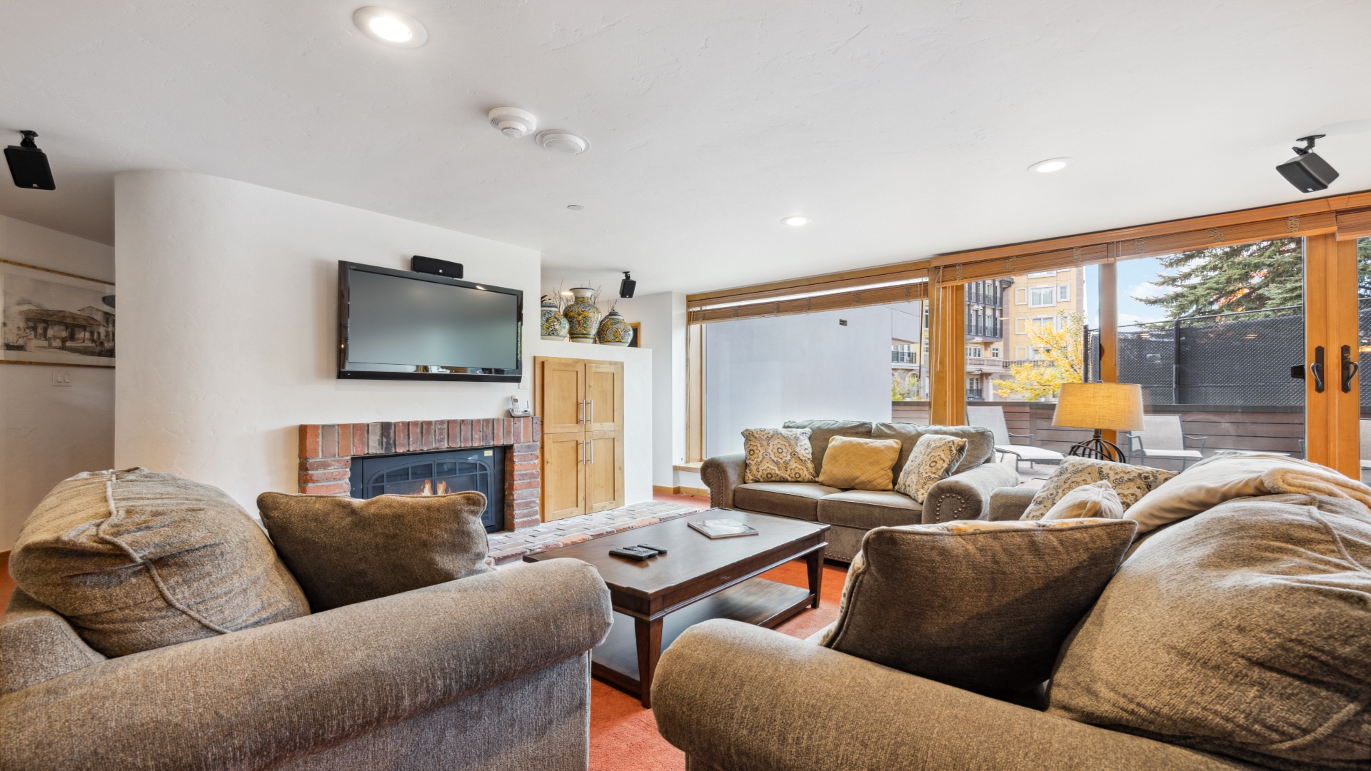 Settle into plush seating by the fireplace with room for everyone. Watch your favorite shows or gaze through large windows at mountain views—your ideal space to unwind.