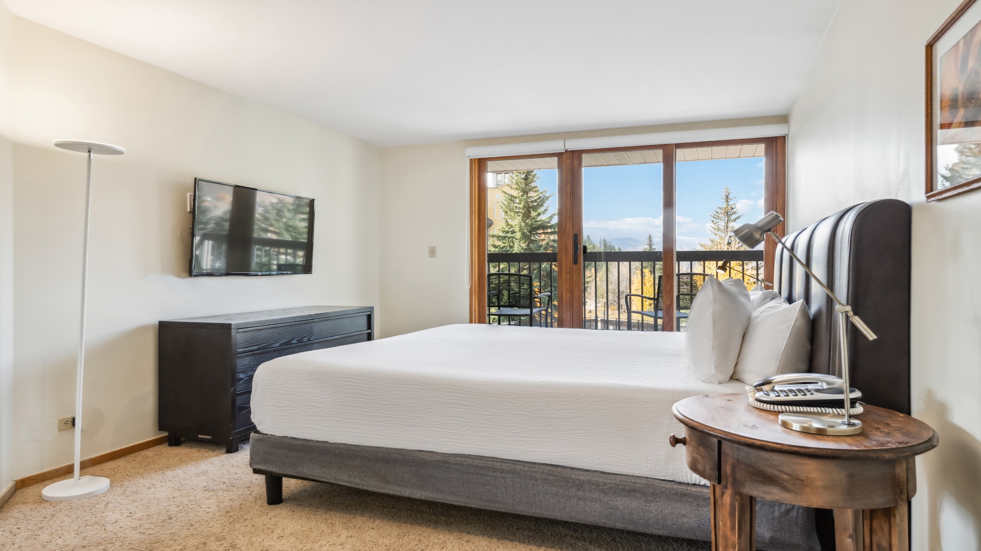 You'll wake to stunning mountain vistas from your plush bed in this serene retreat, where sunlight streams through expansive windows framing towering pines and peaks.