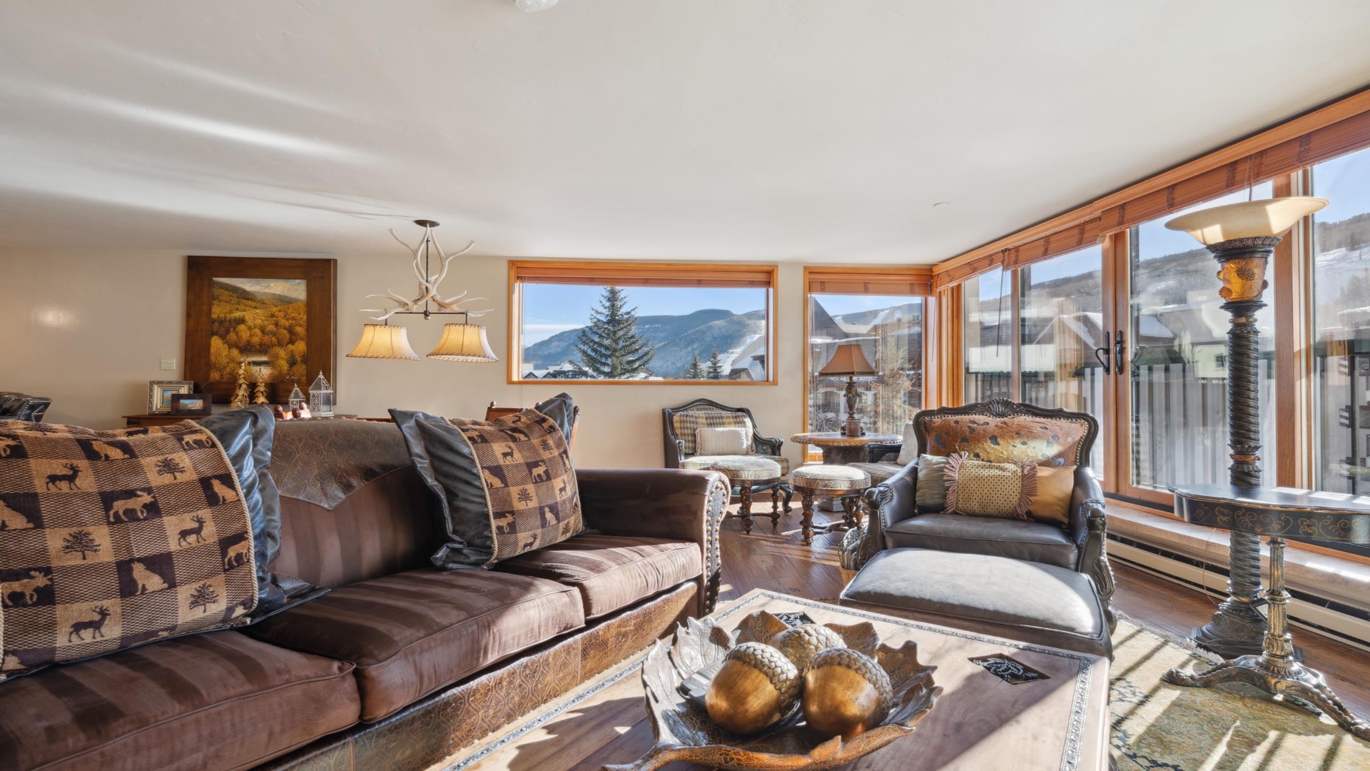 Settle into your cozy mountain retreat with plush seating, warm wood tones, and stunning alpine views framing every moment of your stay.