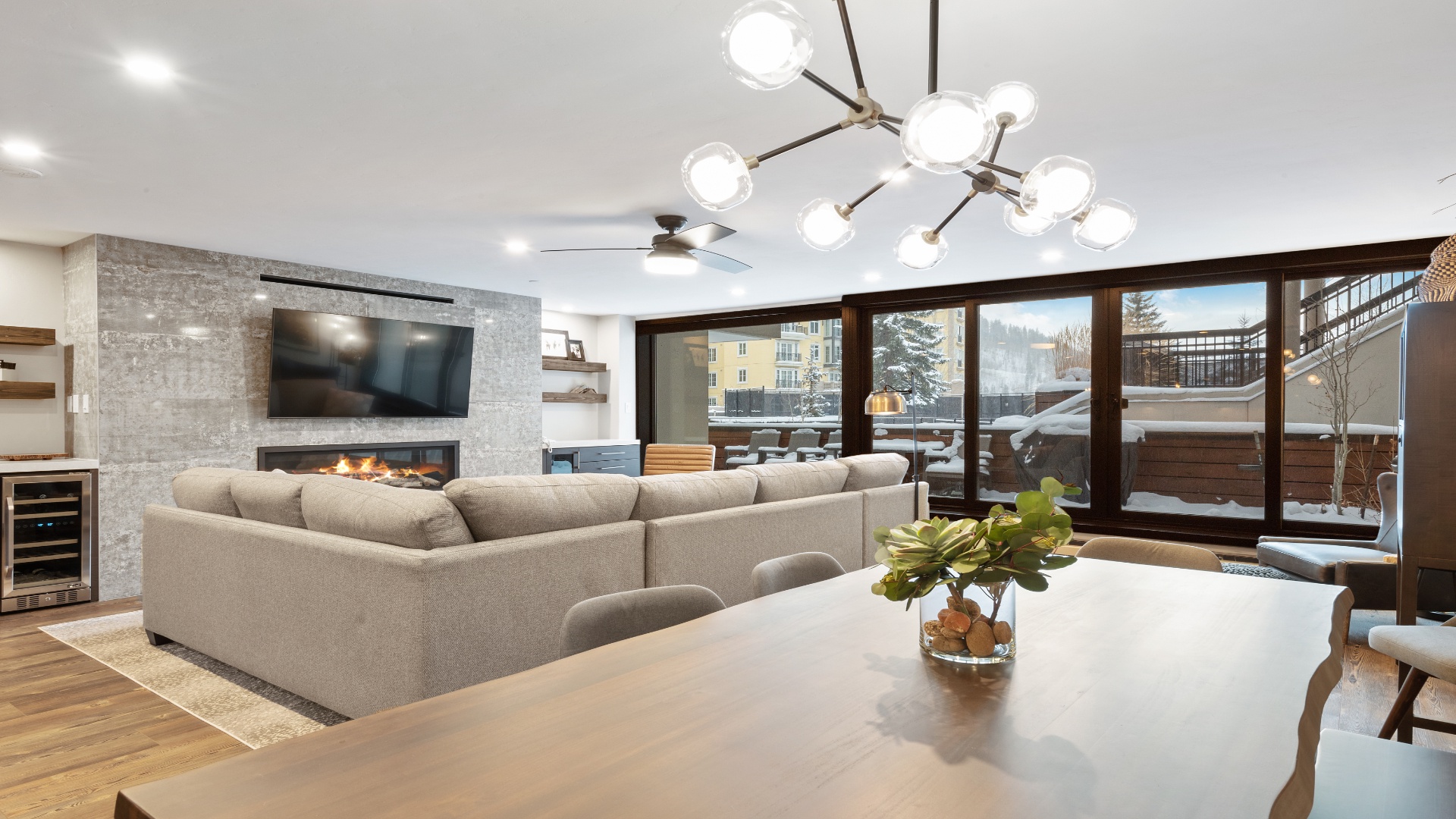 Unwind in your elegant living space with a cozy fireplace, modern entertainment, and stunning mountain views—your perfect après-ski retreat awaits.