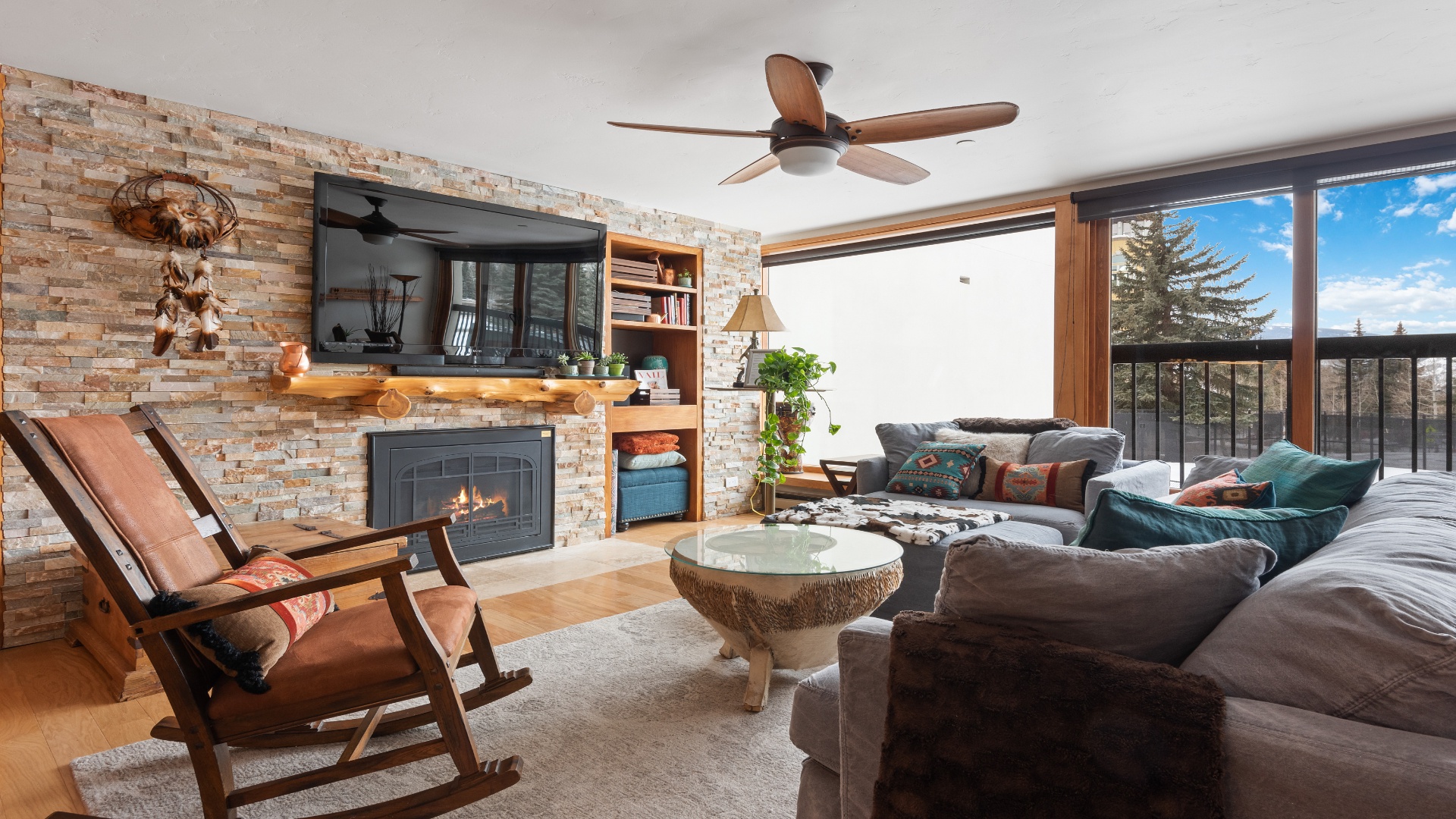 Sink into plush seating by the fireplace and unwind in your cozy mountain retreat, where rustic charm meets modern comfort.