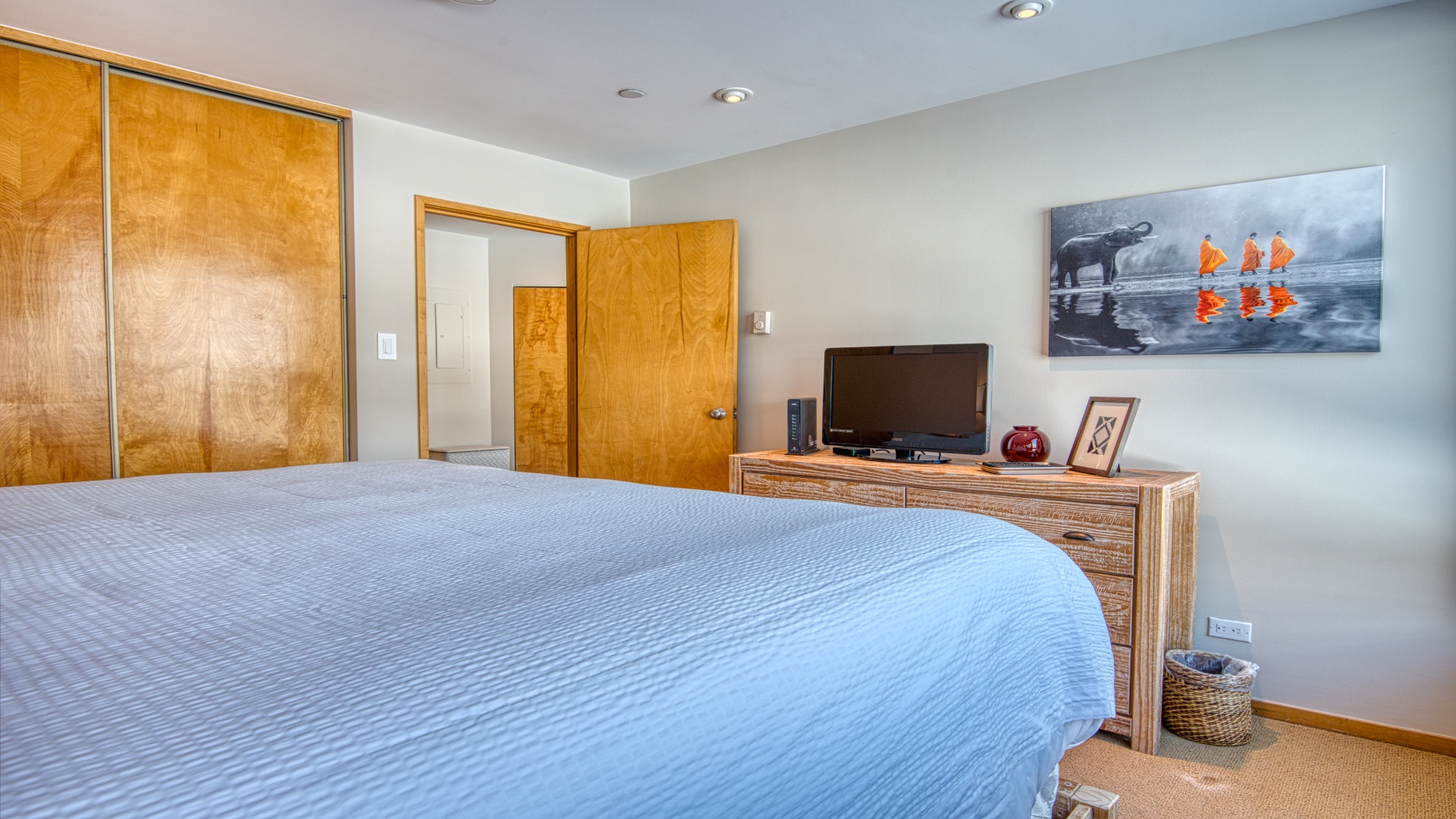 Unwind in your serene bedroom with a plush bed, ample wardrobe space, and entertainment ready for your relaxation after exploring nearby attractions.
