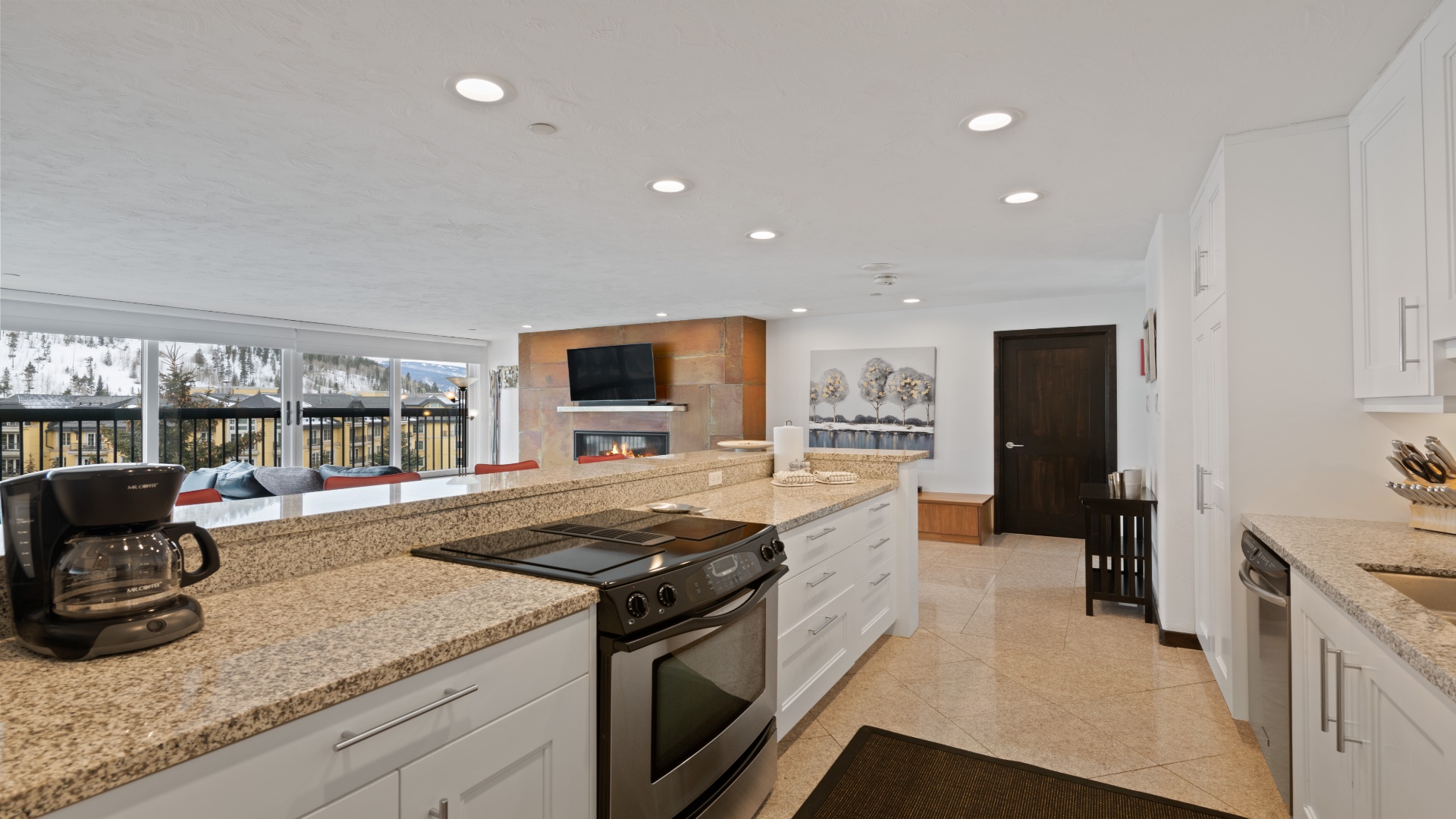 Your spacious open-concept kitchen flows into a cozy living area with a fireplace, perfect for gathering after a day of adventure. Granite counters, stainless appliances, and mountain views make cooking and relaxing effortless.