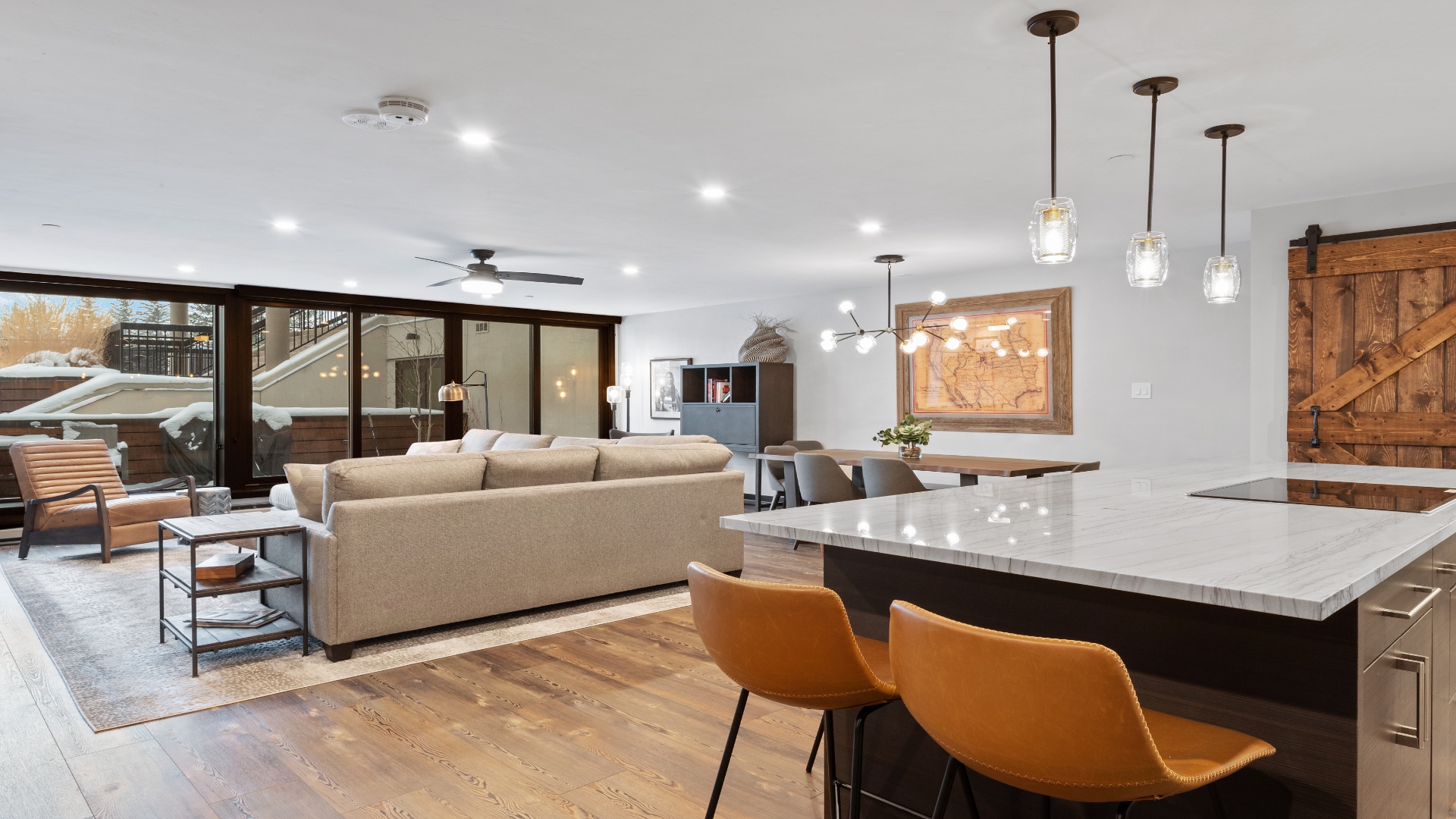 Settle into this sunlit open-concept space where your mountain getaway truly begins. Warm wood tones and modern fixtures create the perfect backdrop for your après-ski evenings and morning coffee rituals.