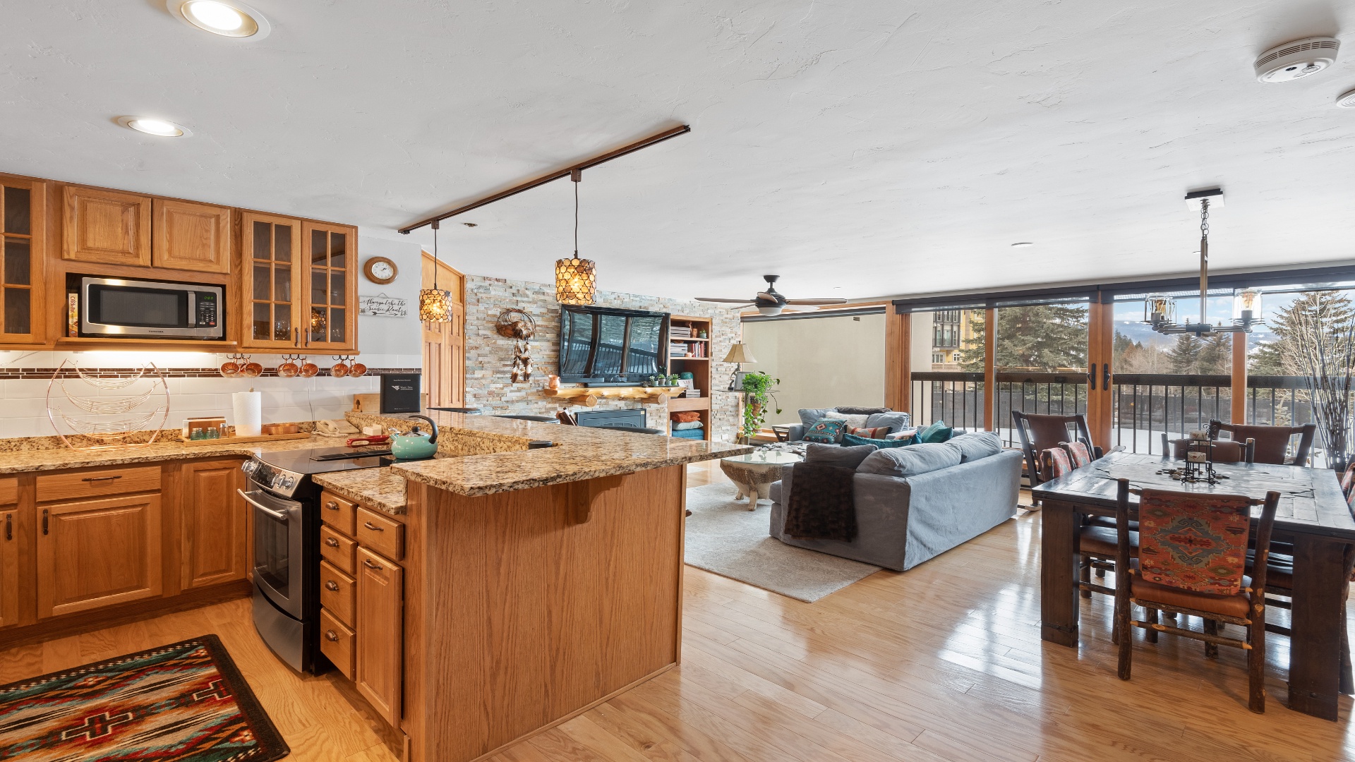 Step into your mountain getaway: an open-concept haven where you'll cook, dine, and unwind surrounded by natural light and stunning balcony views. Every corner invites you to feel at home.