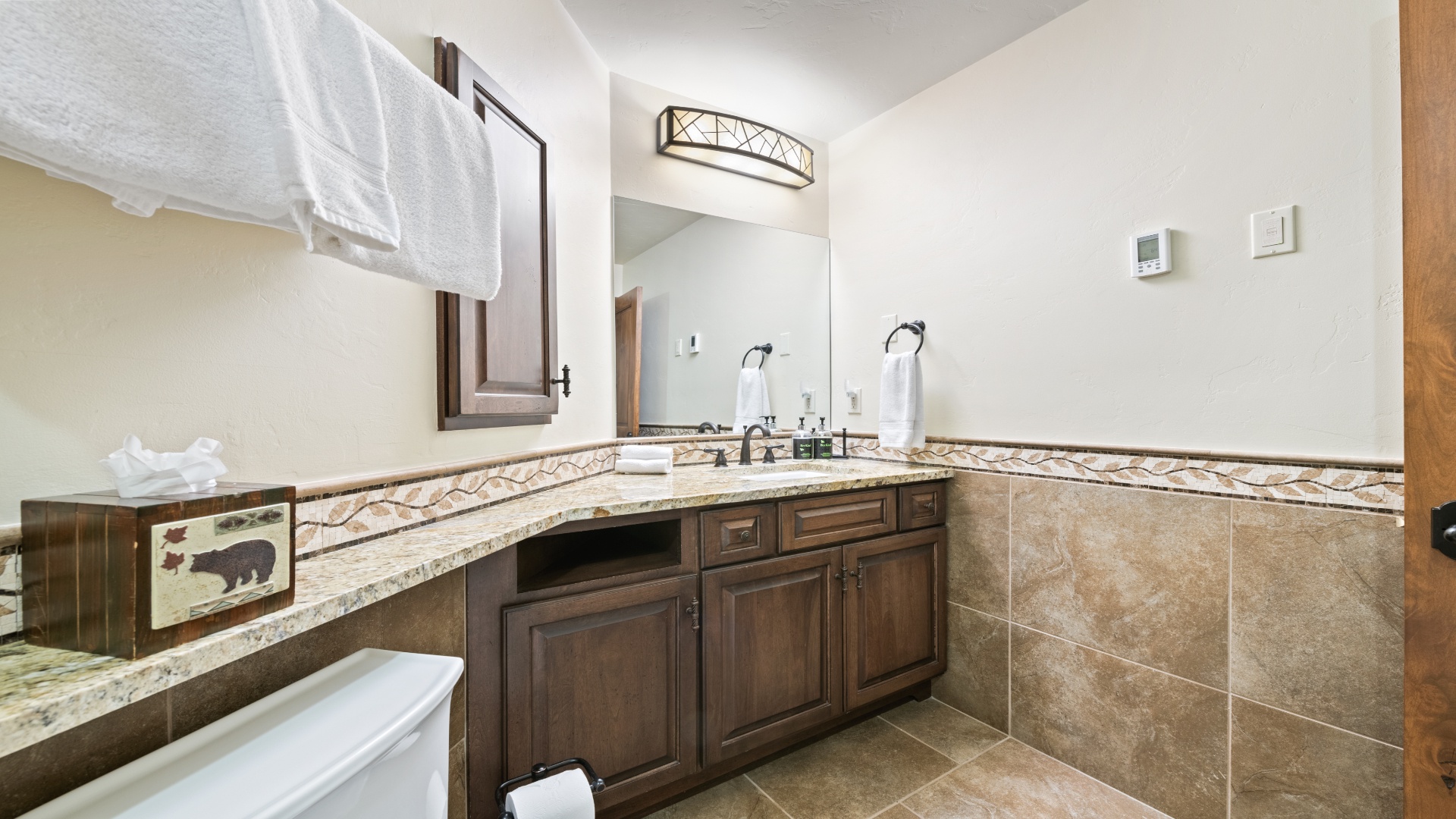Unwind in your spacious bathroom with elegant granite counters, plush towels, and a relaxing tub—perfect for refreshing after a day of adventure.