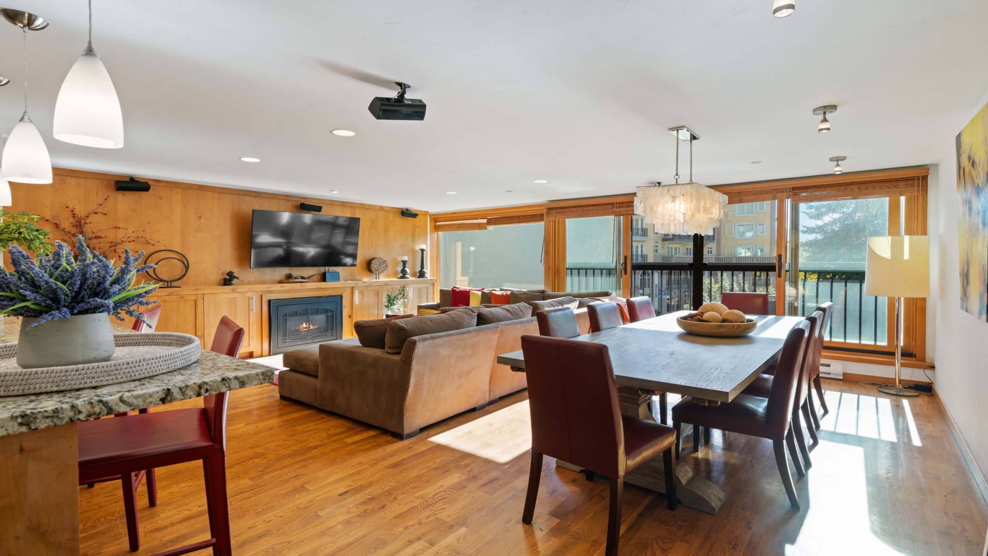 Gather around the spacious dining table or unwind by the cozy fireplace in this bright, open living area with stunning lake views just beyond your windows.