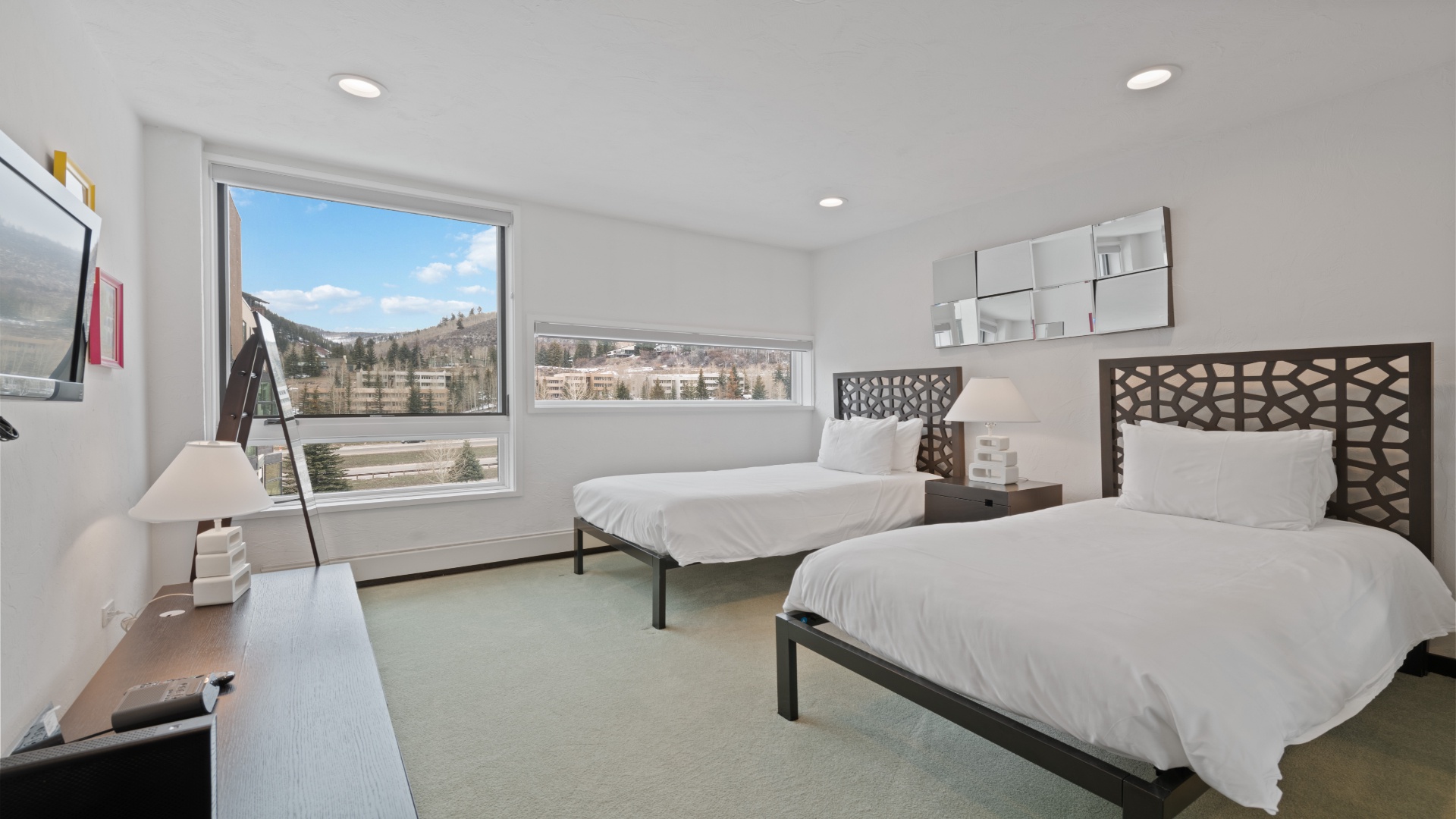 Wake to mountain vistas from twin beds in a bright, modern room that welcomes you with crisp linens and open skies.