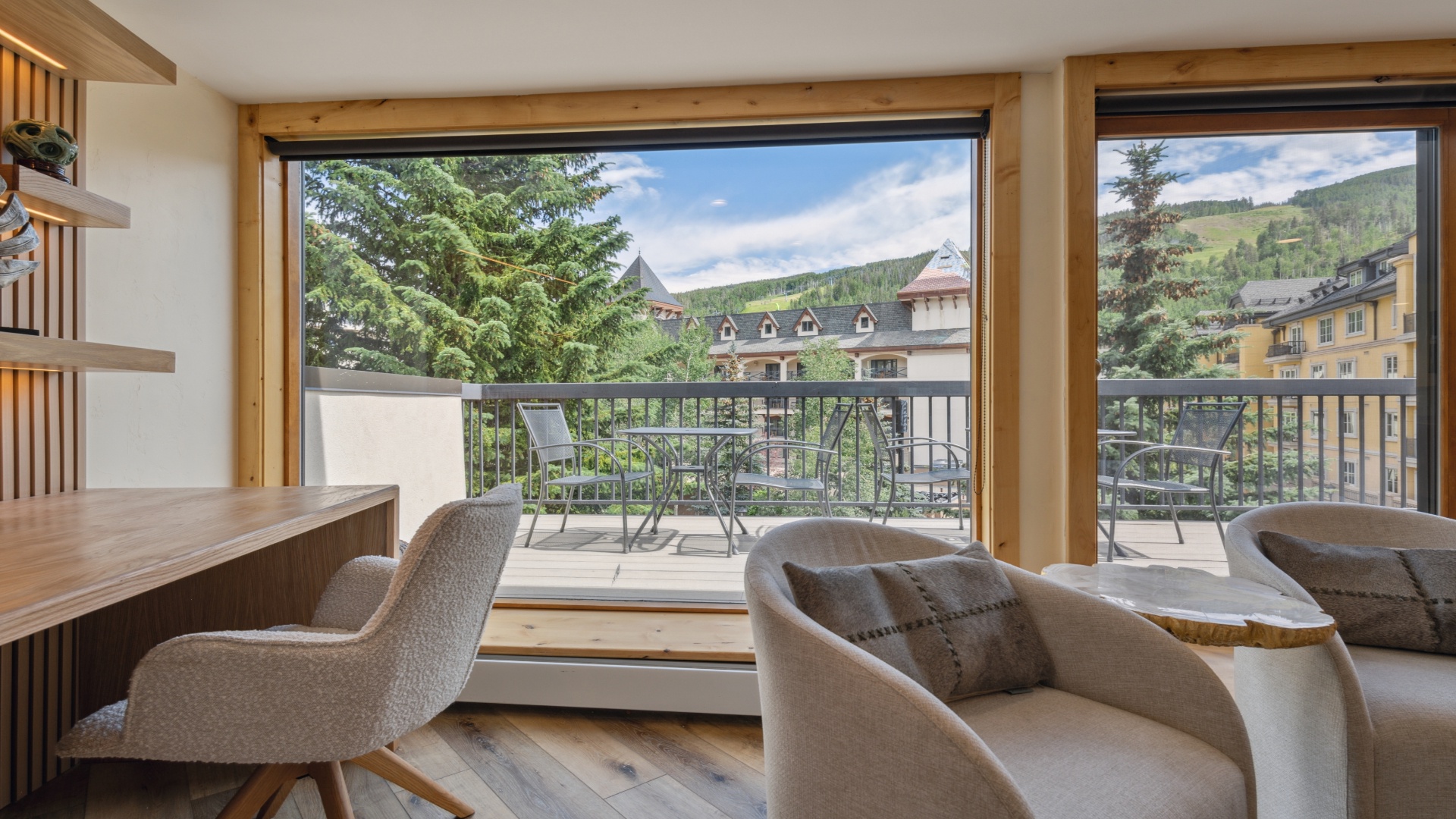 Relax in your cozy living area with sweeping mountain views through expansive windows. Step onto the private balcony and breathe in the fresh alpine air while enjoying the scenic village surroundings.