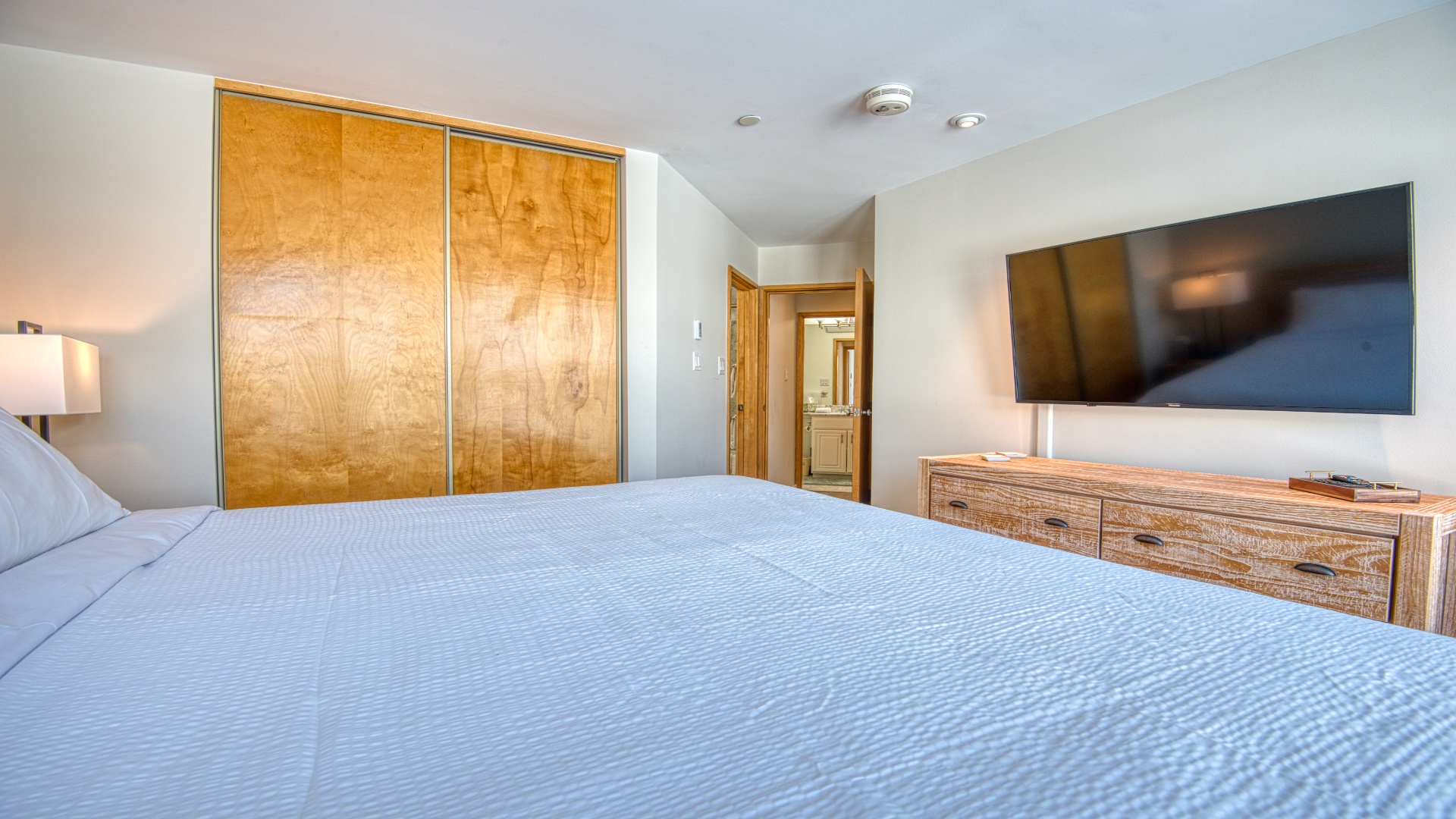 Sink into crisp, fresh linens and feel truly at home. Your bedroom features warm wood tones, modern amenities, and calming design—perfect for restful nights after exploring.
