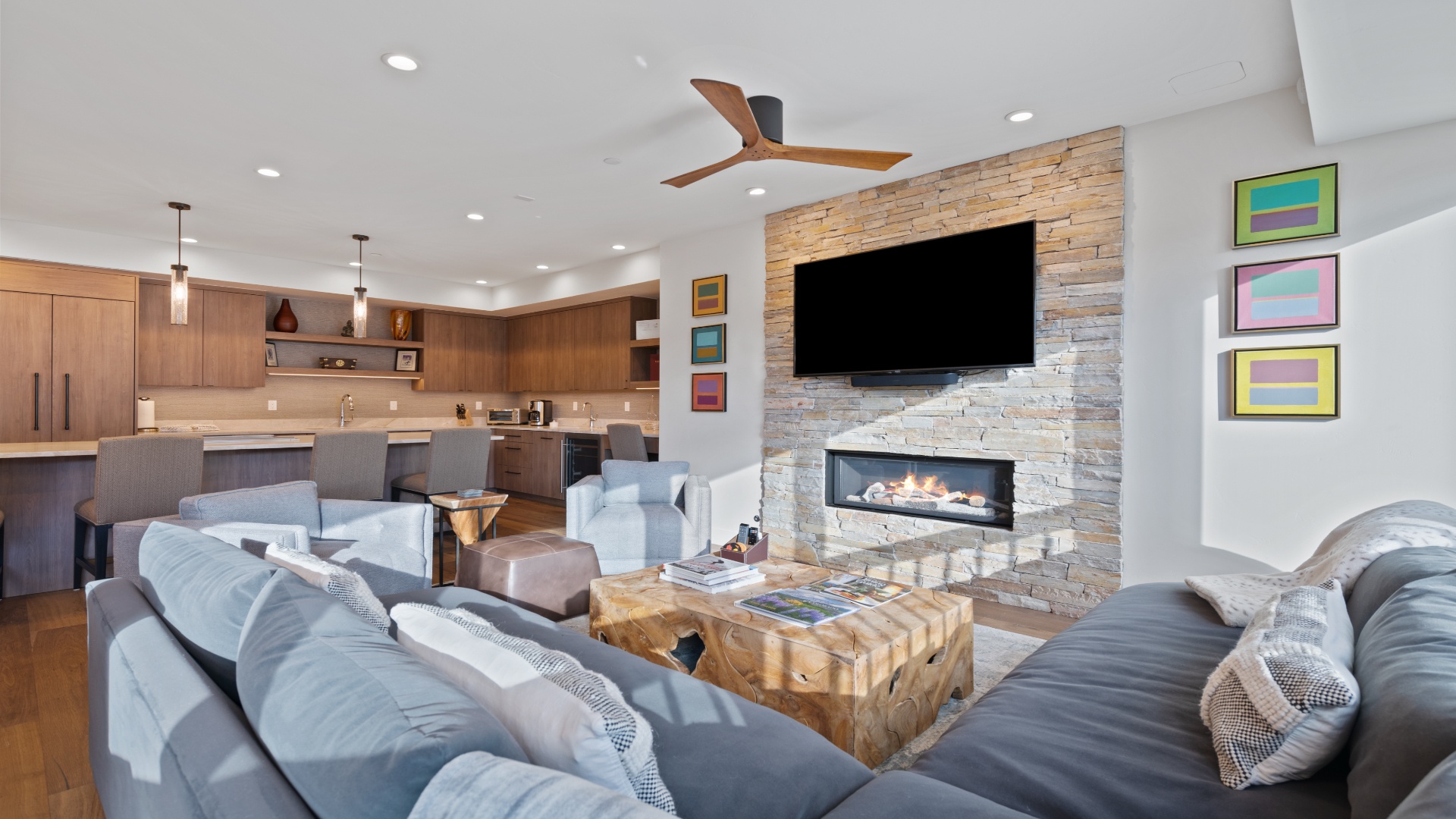Relax in your bright, open-plan living area with cozy seating, a modern fireplace, and a sleek entertainment setup. The full kitchen and stylish accents make it your perfect home away from home.