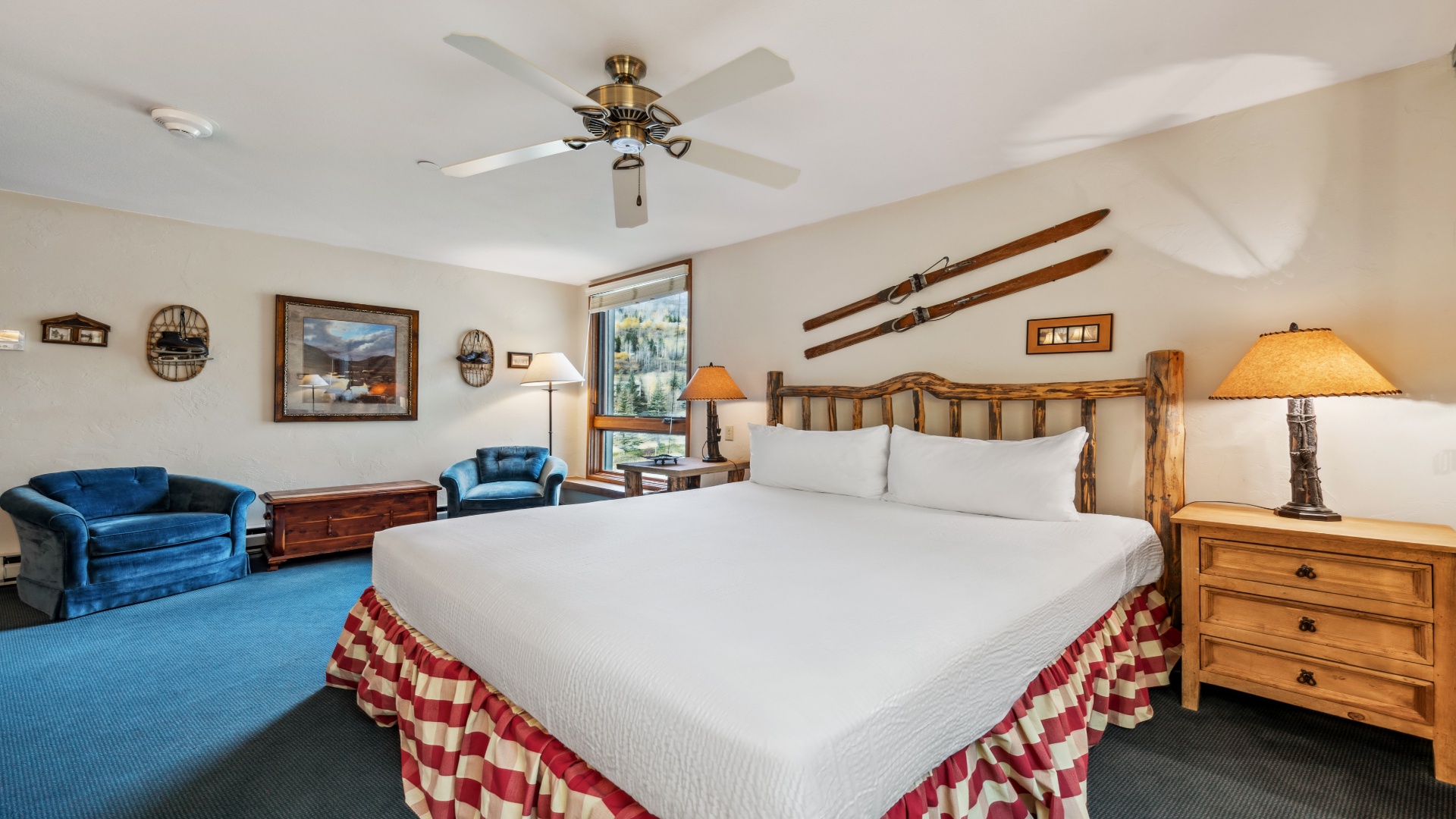 Unwind in your cozy mountain retreat with rustic log-style furnishings, a plush king bed, and a comfortable seating area perfect for relaxing after your adventures.