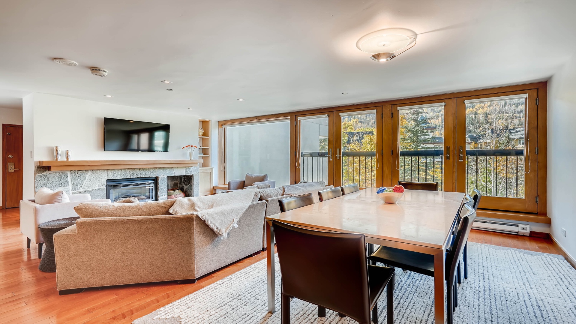 Gather around the spacious dining table or sink into the cozy sofa, where natural light streams through the doors and frames peaceful views beyond, creating your perfect retreat.