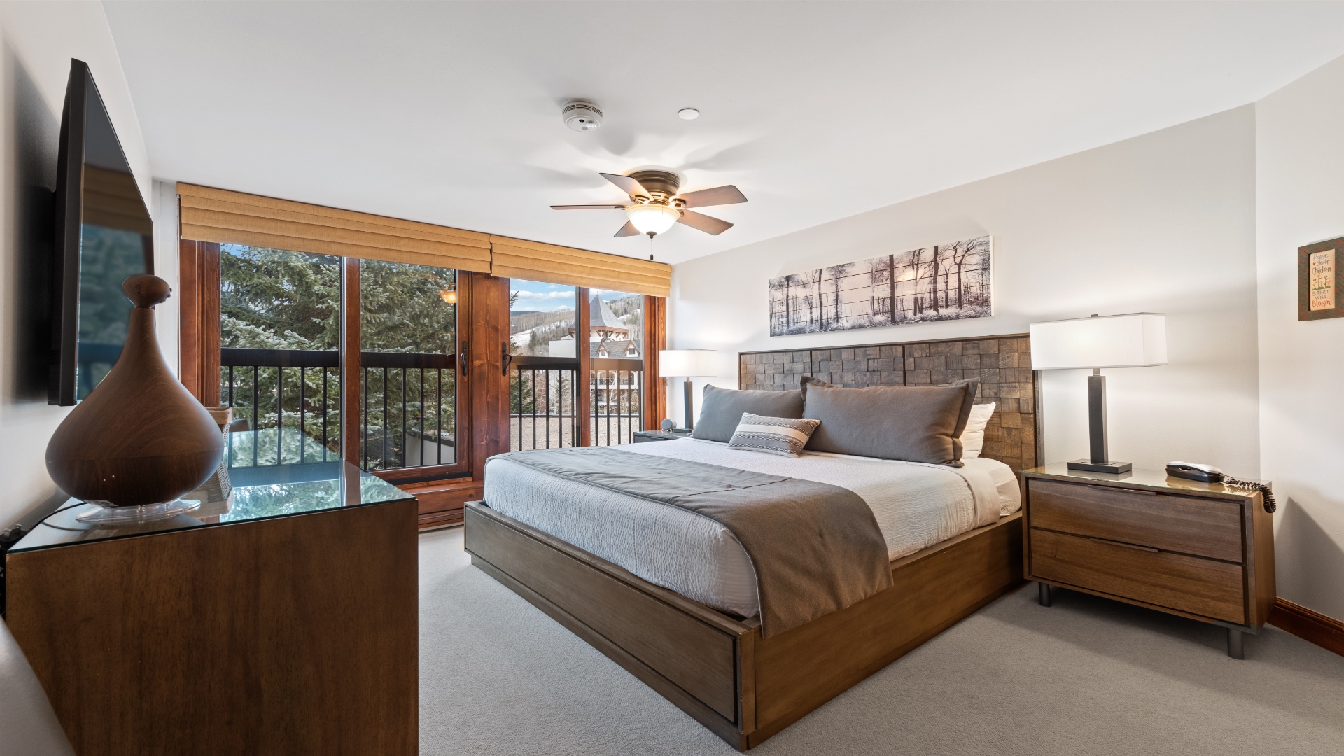 Rest easy in your serene bedroom with plush bedding and a ceiling fan. Step onto your private balcony to take in peaceful treetop and mountain vistas.
