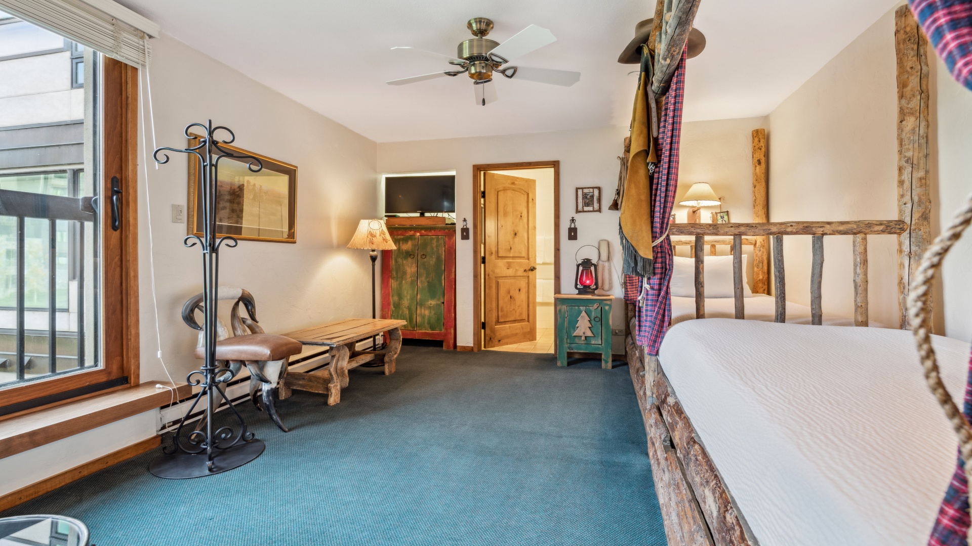 Relax in your cozy rustic retreat, featuring handcrafted log furniture, warm wood accents, and charming vintage touches that create an authentic mountain getaway atmosphere.