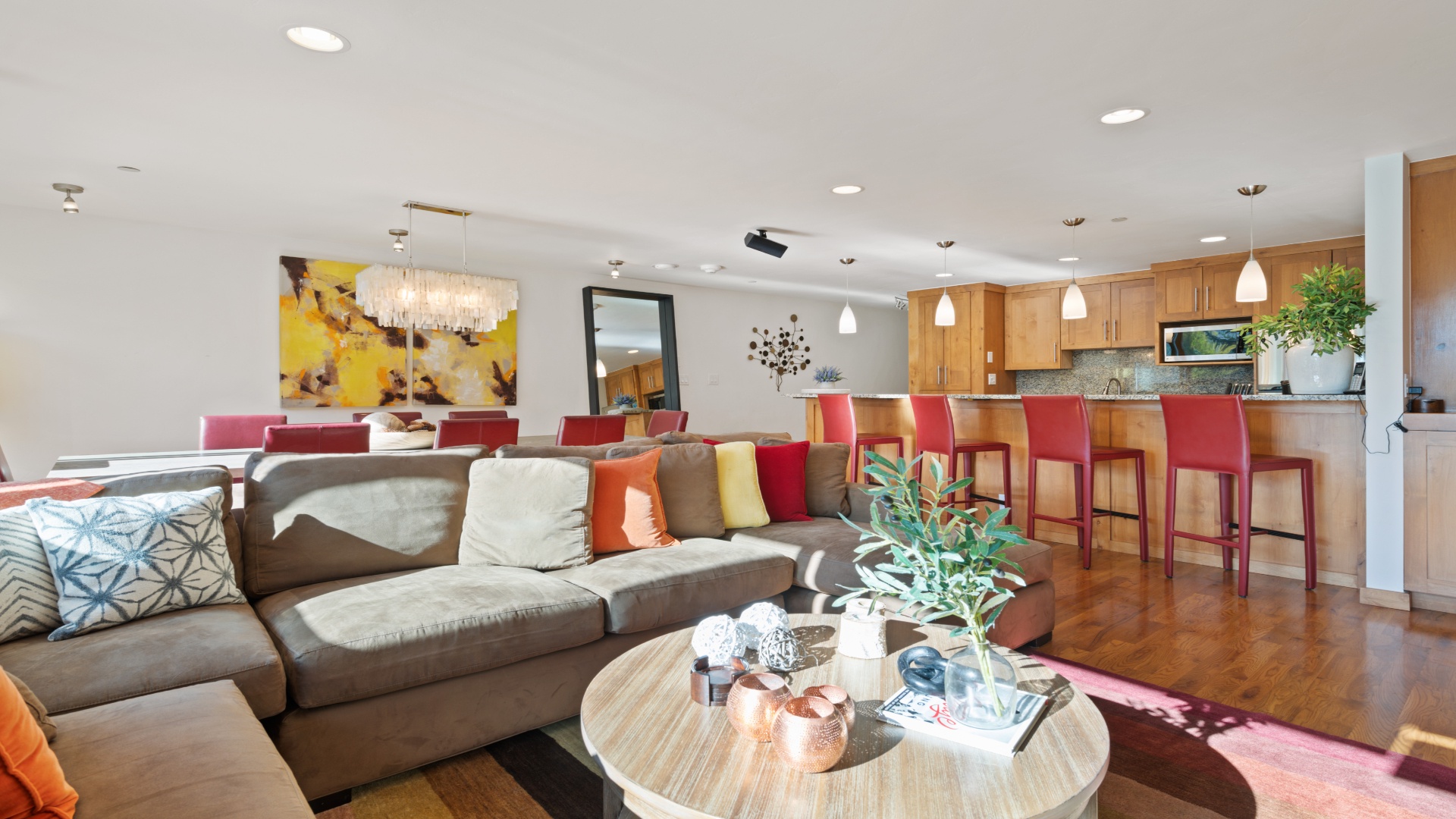 Settle into your spacious open-concept retreat where warm wood tones and vibrant pops of color create the perfect backdrop for memorable gatherings with family and friends.