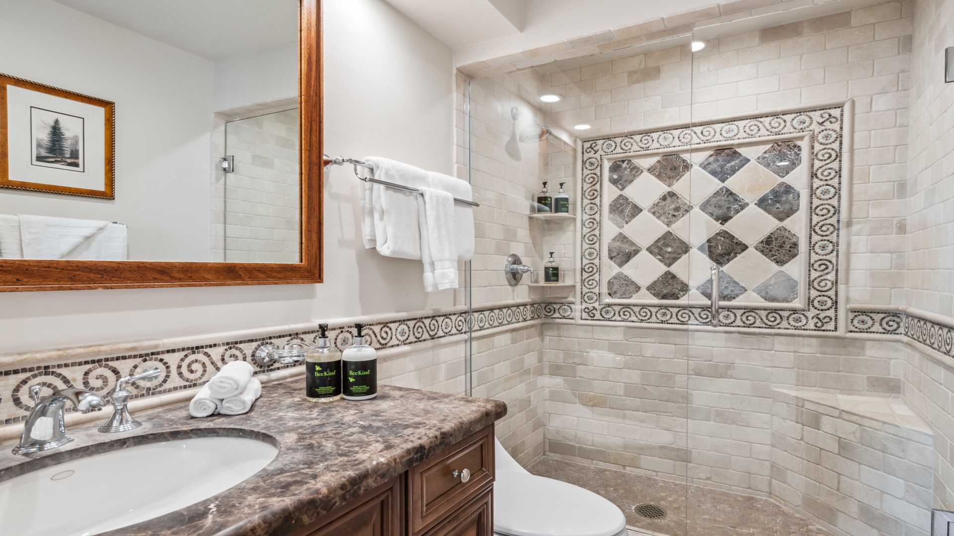 Step into your beautifully tiled bathroom, where elegant mosaics and warm wood accents create a spa-like retreat for your morning refresh.