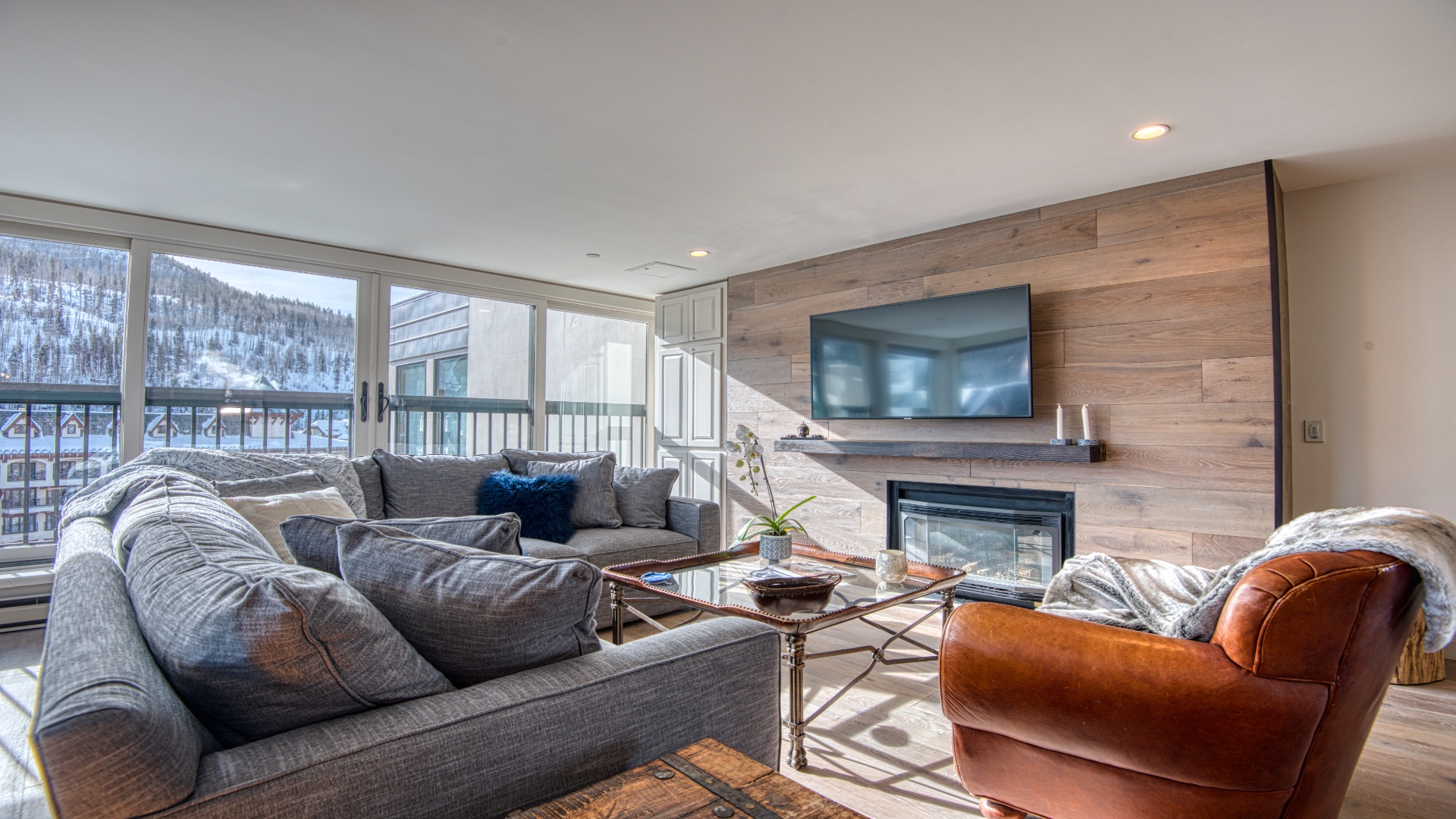 Sink into plush seating after a day on the slopes, warmed by the fireplace as you gaze at the snowy mountains through oversized windows.