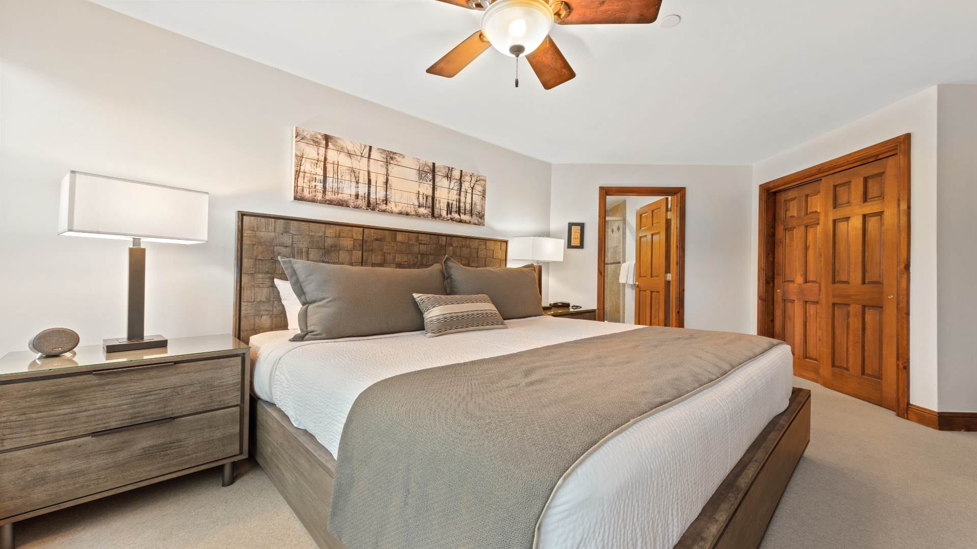 Settle into your serene bedroom, where soft linens, calming earth tones, and a gentle ceiling fan create a peaceful retreat for restful nights.