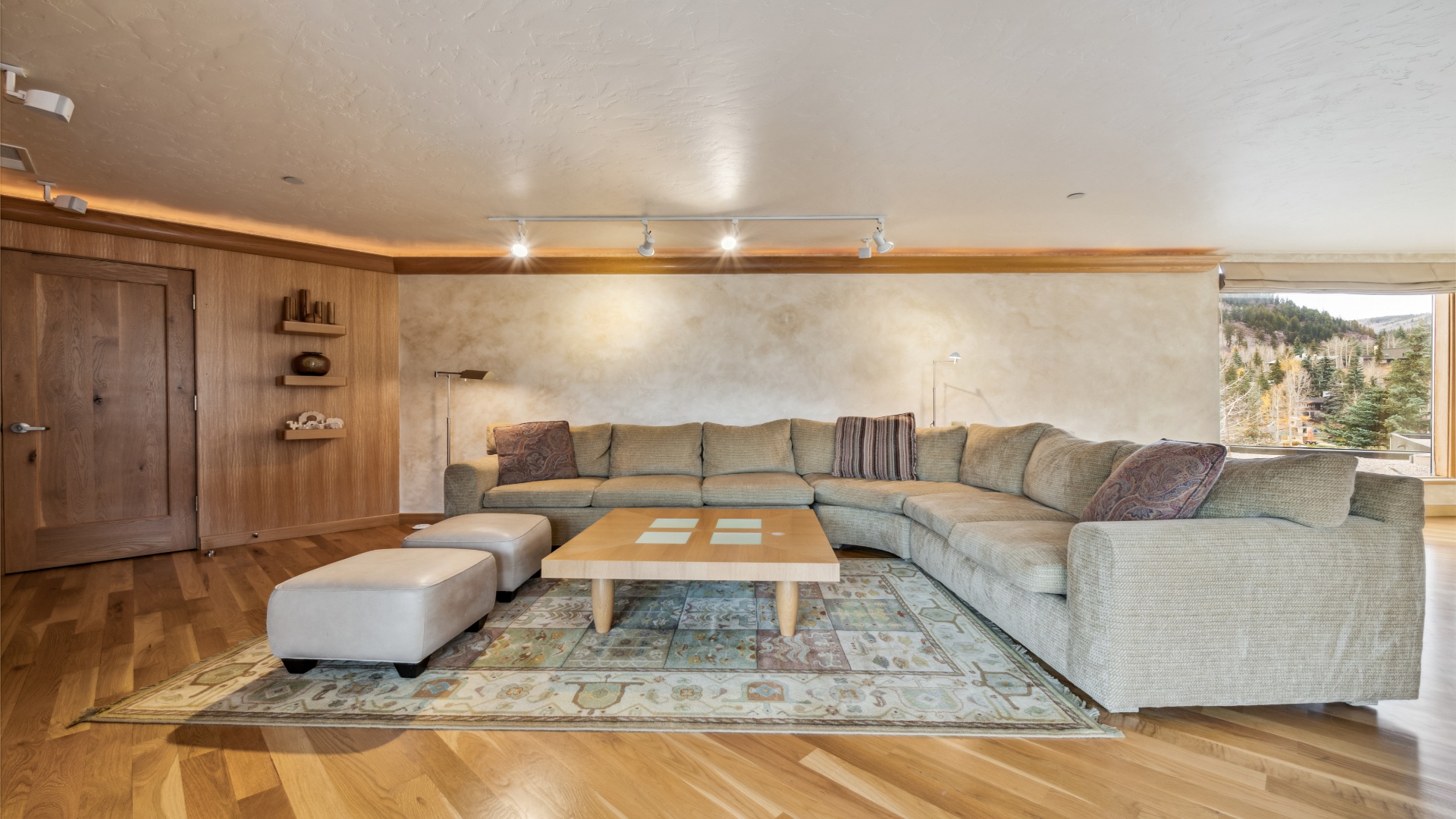 Unwind in your spacious living room where a plush sectional sofa and mountain views create the perfect alpine retreat for relaxation and connection.