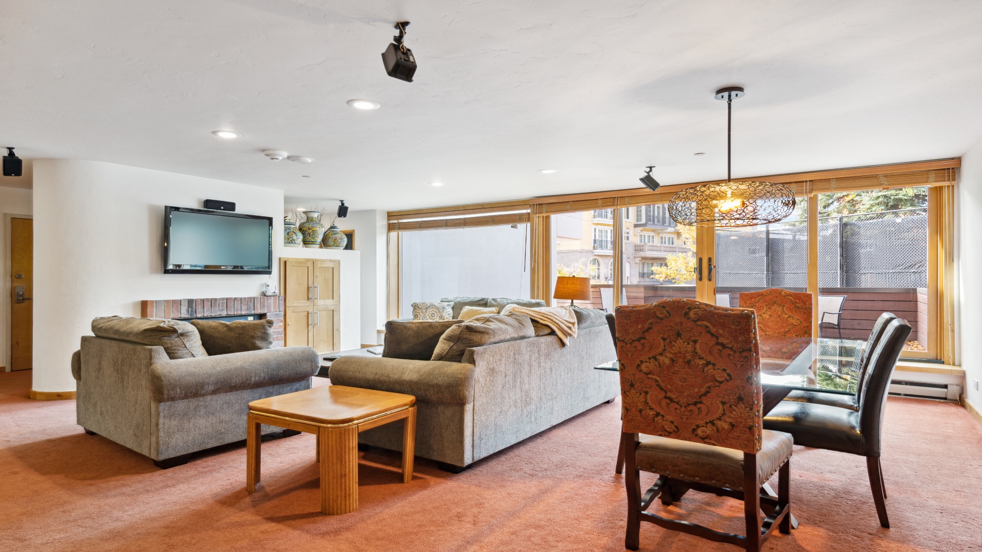 Settle into your spacious living room where plush sofas invite relaxation and sunlight streams through sliding doors to your private terrace. Perfect for unwinding after exploring.