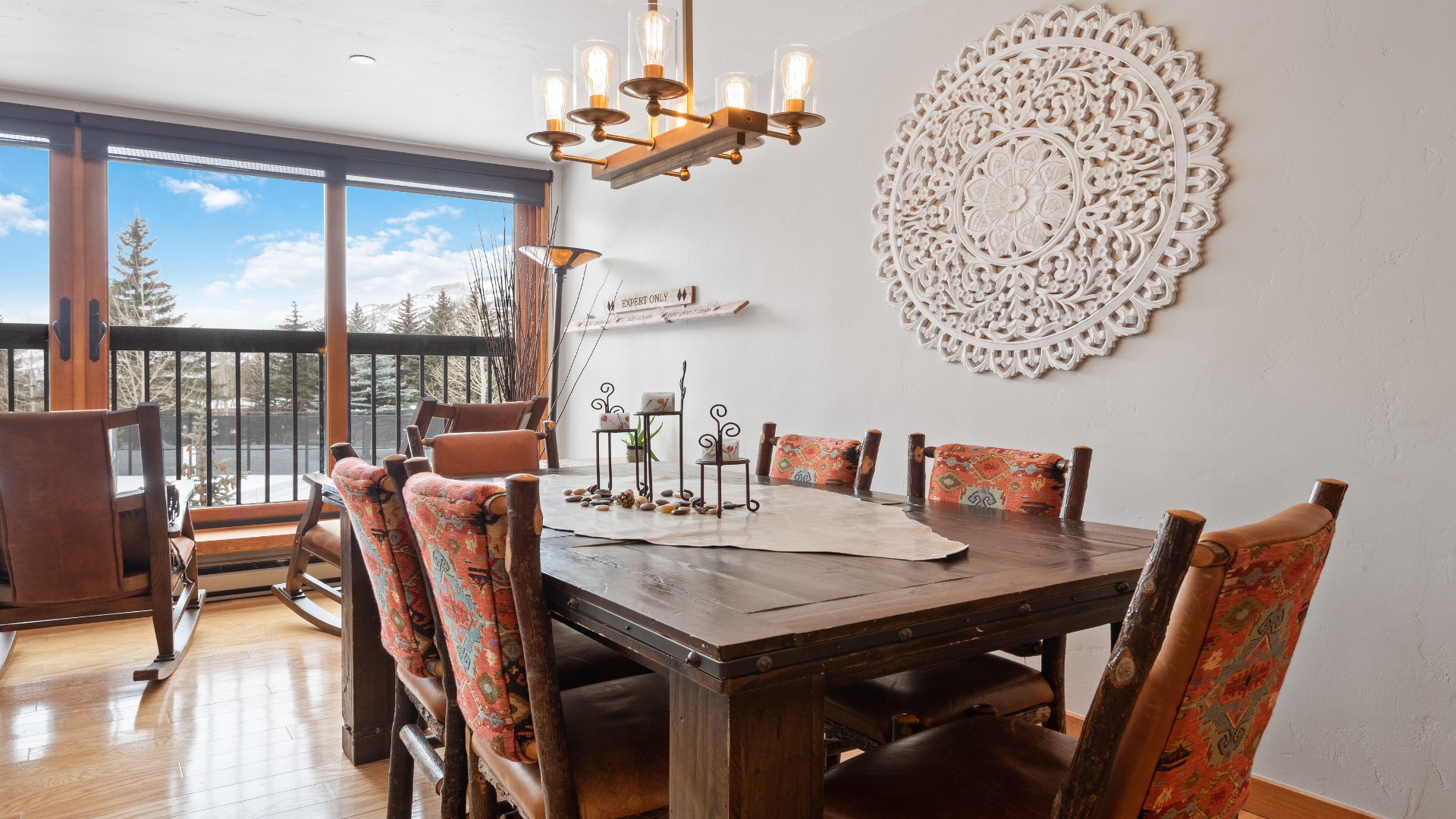 Your dining space welcomes you with warm wood tones, artisan touches, and a stunning view through the balcony doors—perfect for memorable meals together.