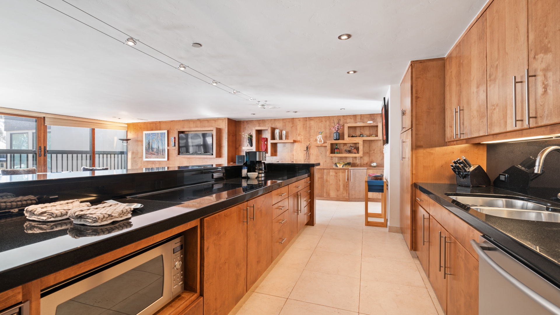 Your dream chef's kitchen awaits with sleek black countertops, warm wood cabinetry, and all the tools you need to whip up delicious meals during your stay.