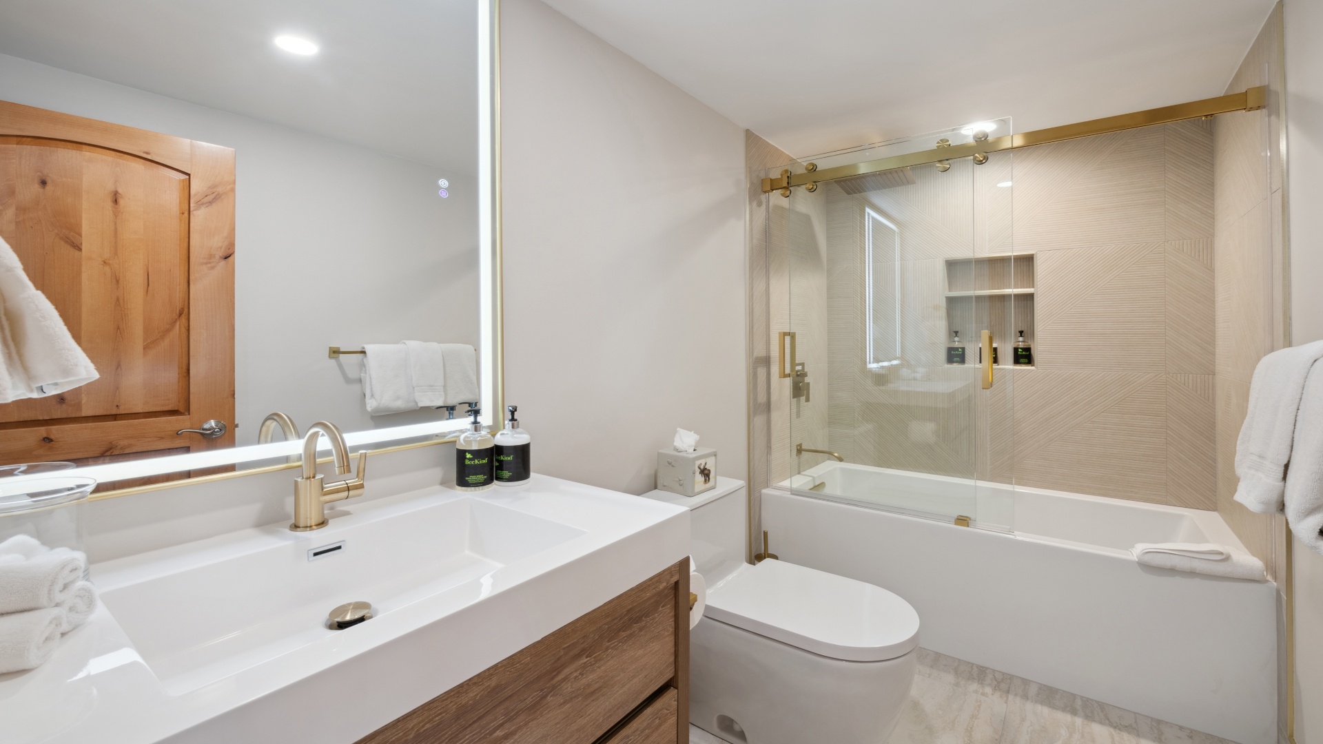 Unwind in your modern bathroom with a deep soaking tub, sleek glass enclosure, and premium amenities. Soft towels and warm wood accents create a spa-like retreat after your adventures.
