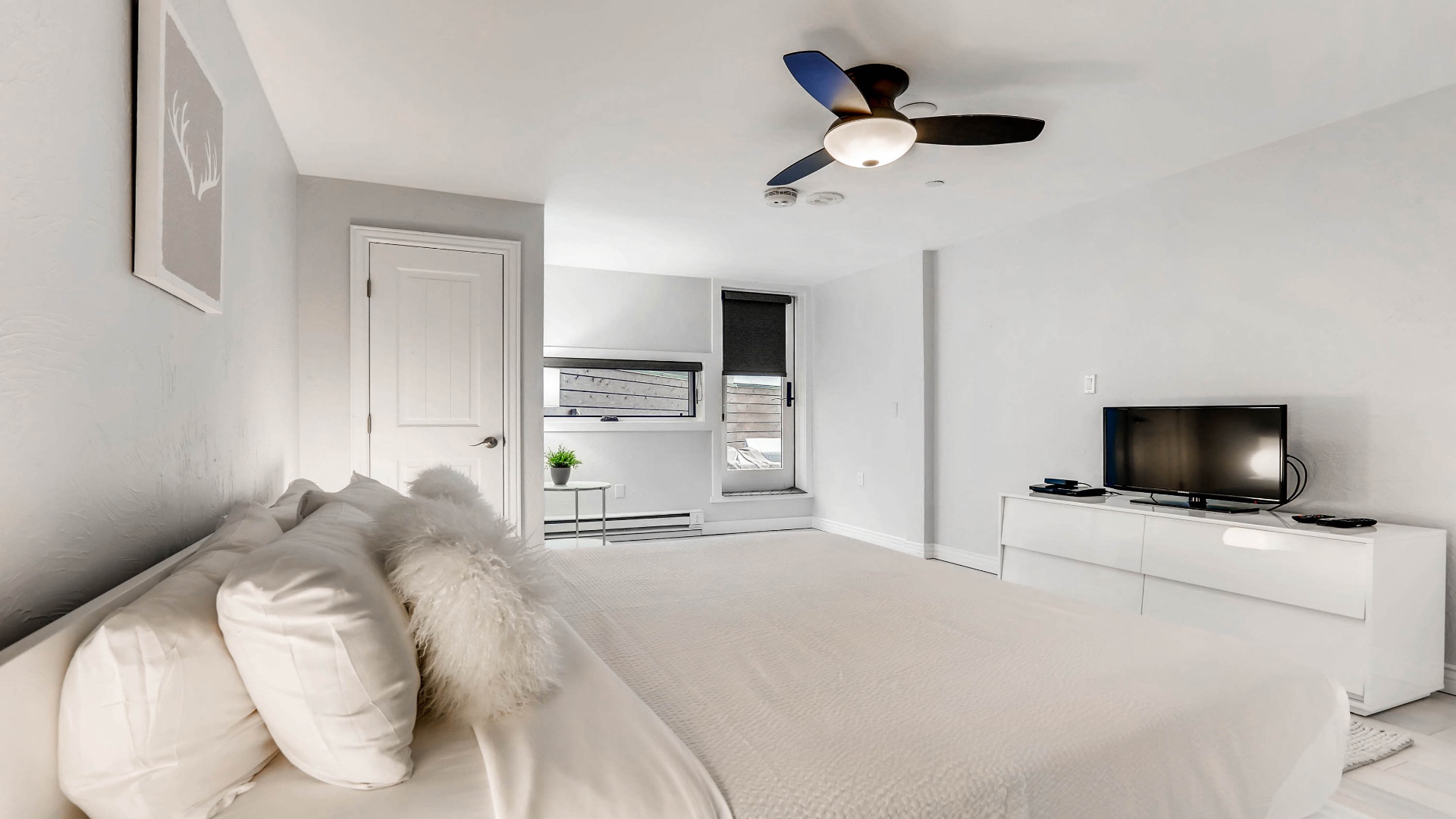 Unwind in your serene retreat with plush bedding, a ceiling fan for comfort, and entertainment at your fingertips—your peaceful escape awaits.