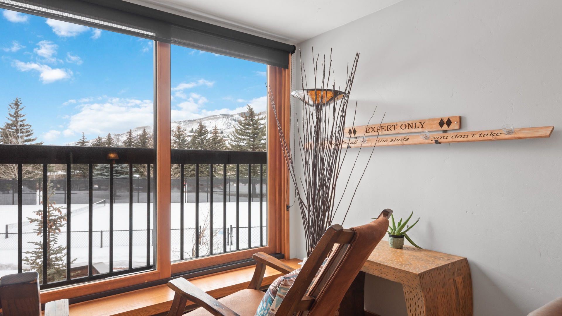 Settle into your cozy chair, take in the stunning mountain views through expansive windows, and let the snow-dusted landscape inspire your next adventure from this serene retreat.
